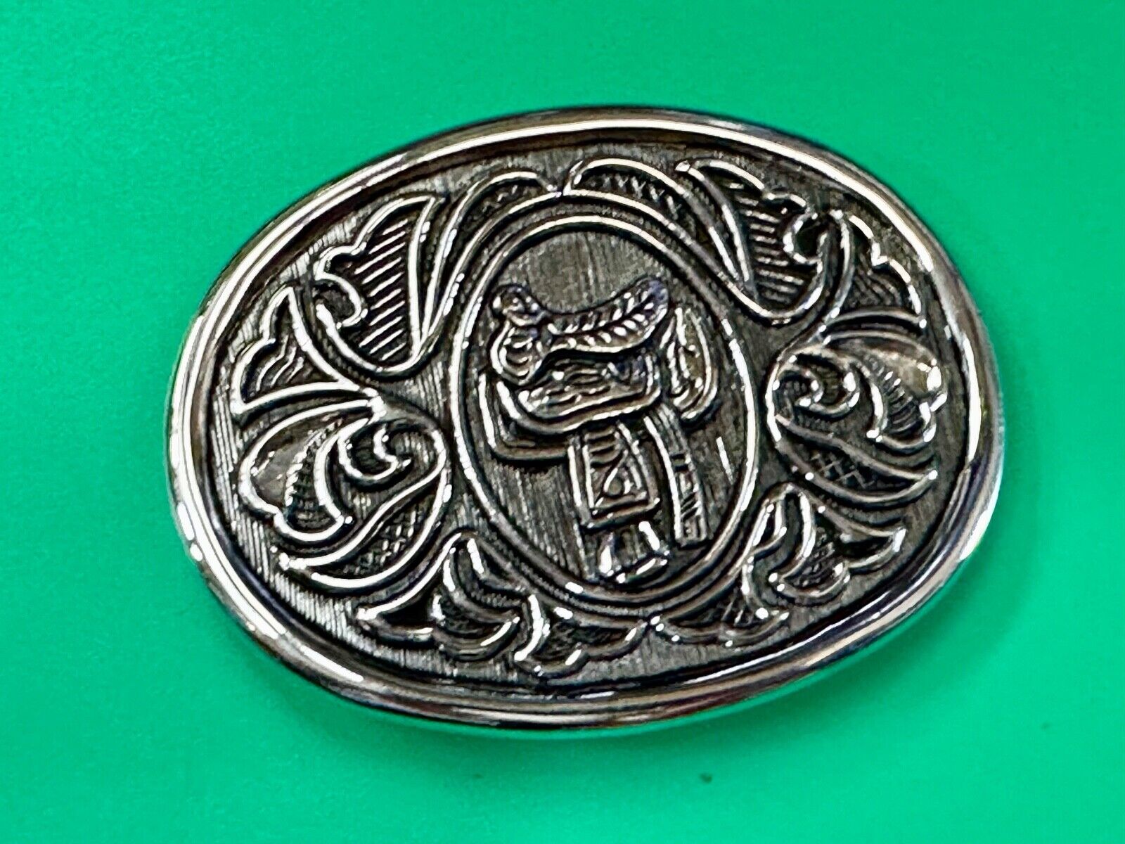 Vintage Cowboy's Horse Saddle ornate flower swirl oval belt buckle by Avon