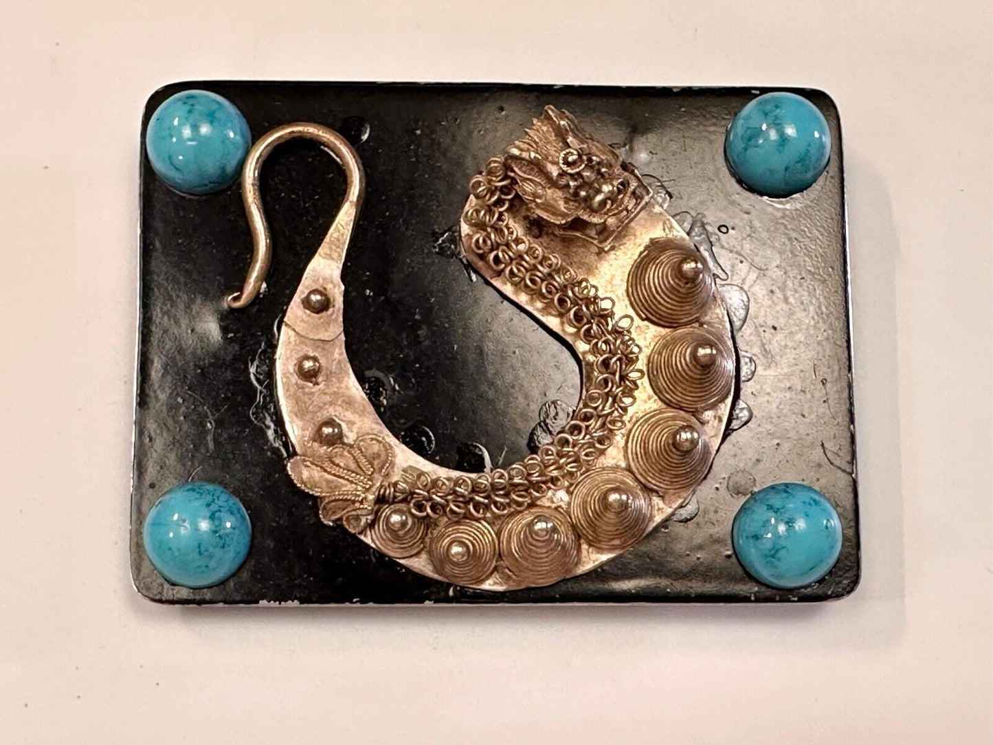 Artisan Dragon theme rectangular belt buckle with turquoise colored corner accts