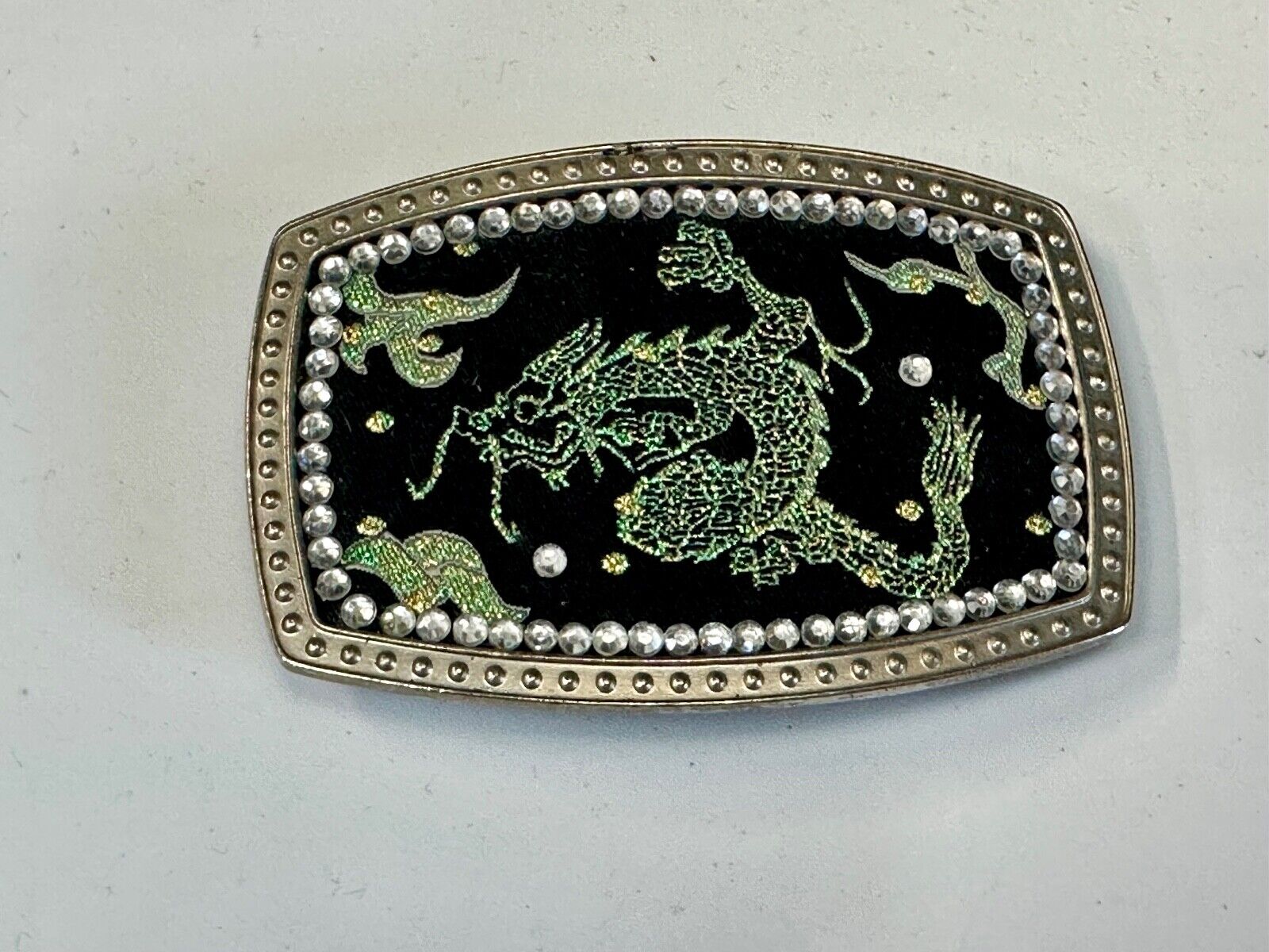 Chinese Dragon pattern symbol on silver tone rhinestone accented belt buckle