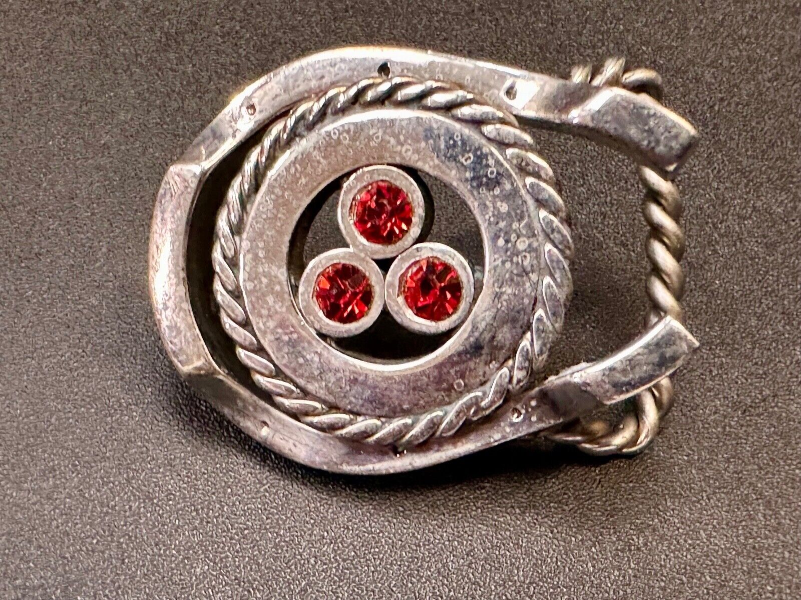 artisan circle pattern rope centerpiece red dots horseshoe shaped belt buckle