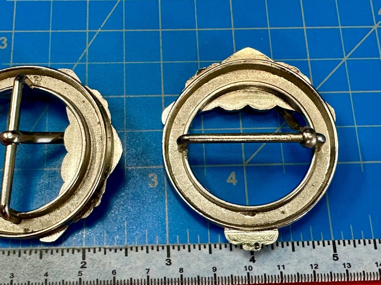 Two Kathy Van Zeeland signed silver tone round heart accented belt buckles