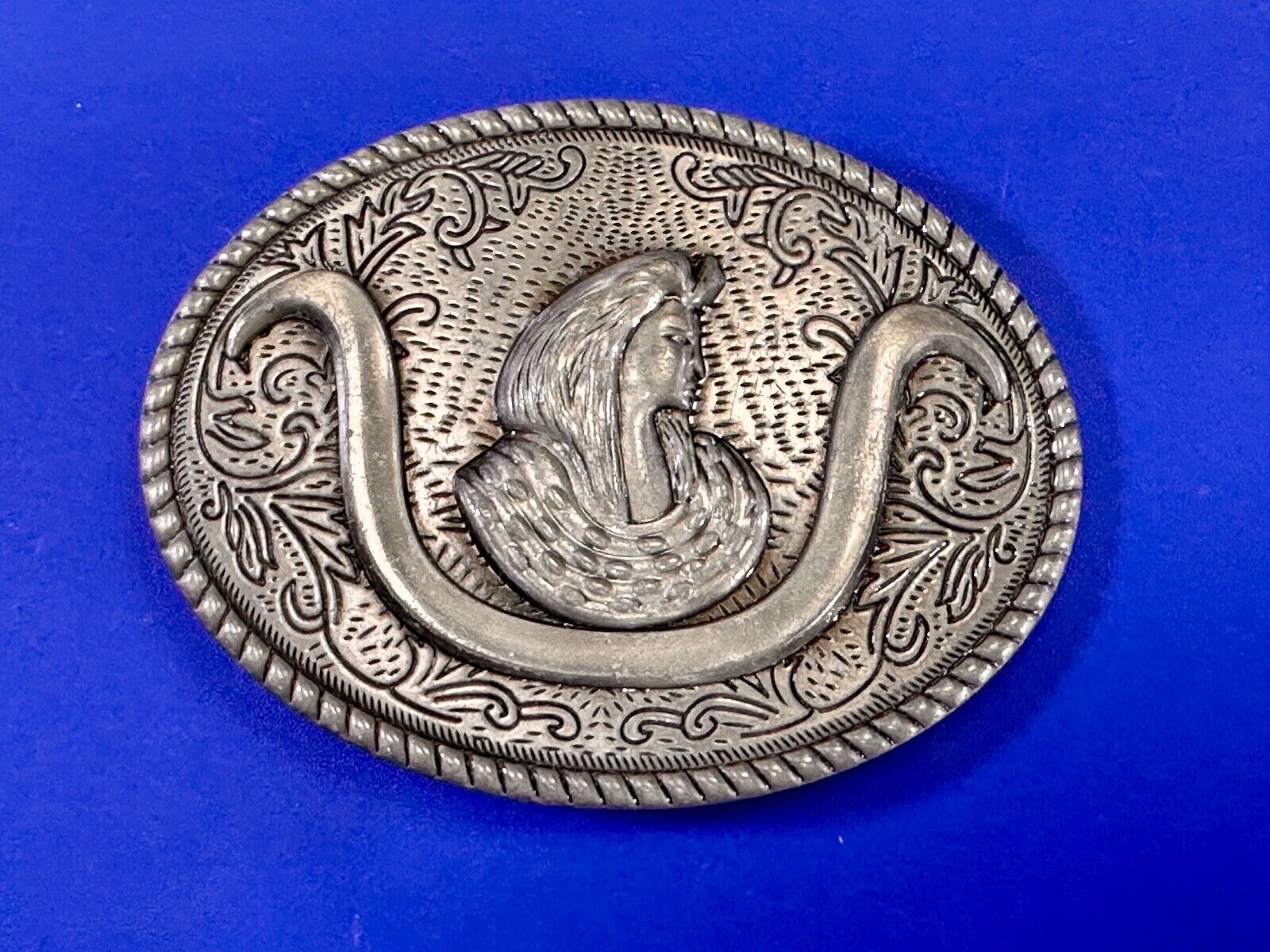 unknown to me!   Man with long hair - longhorn wester belt buckle