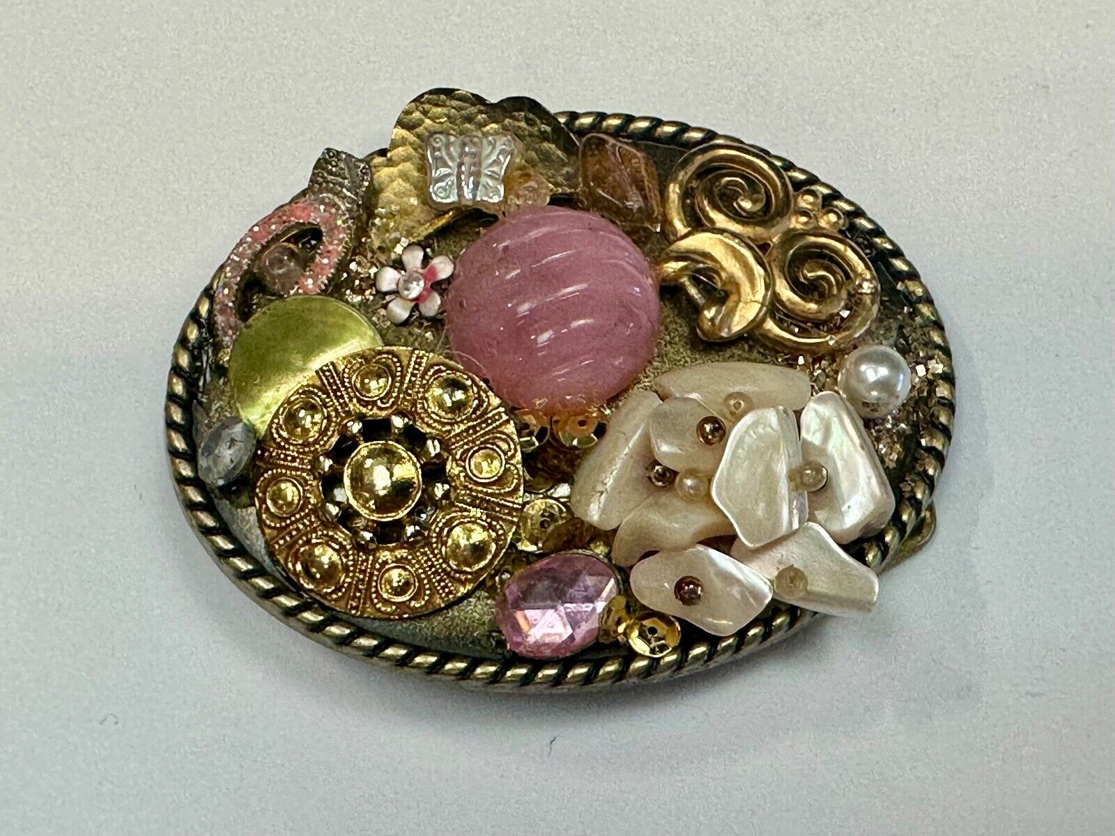 Artisan Abstract flowers made of mixed material on gold tone oval belt buckle