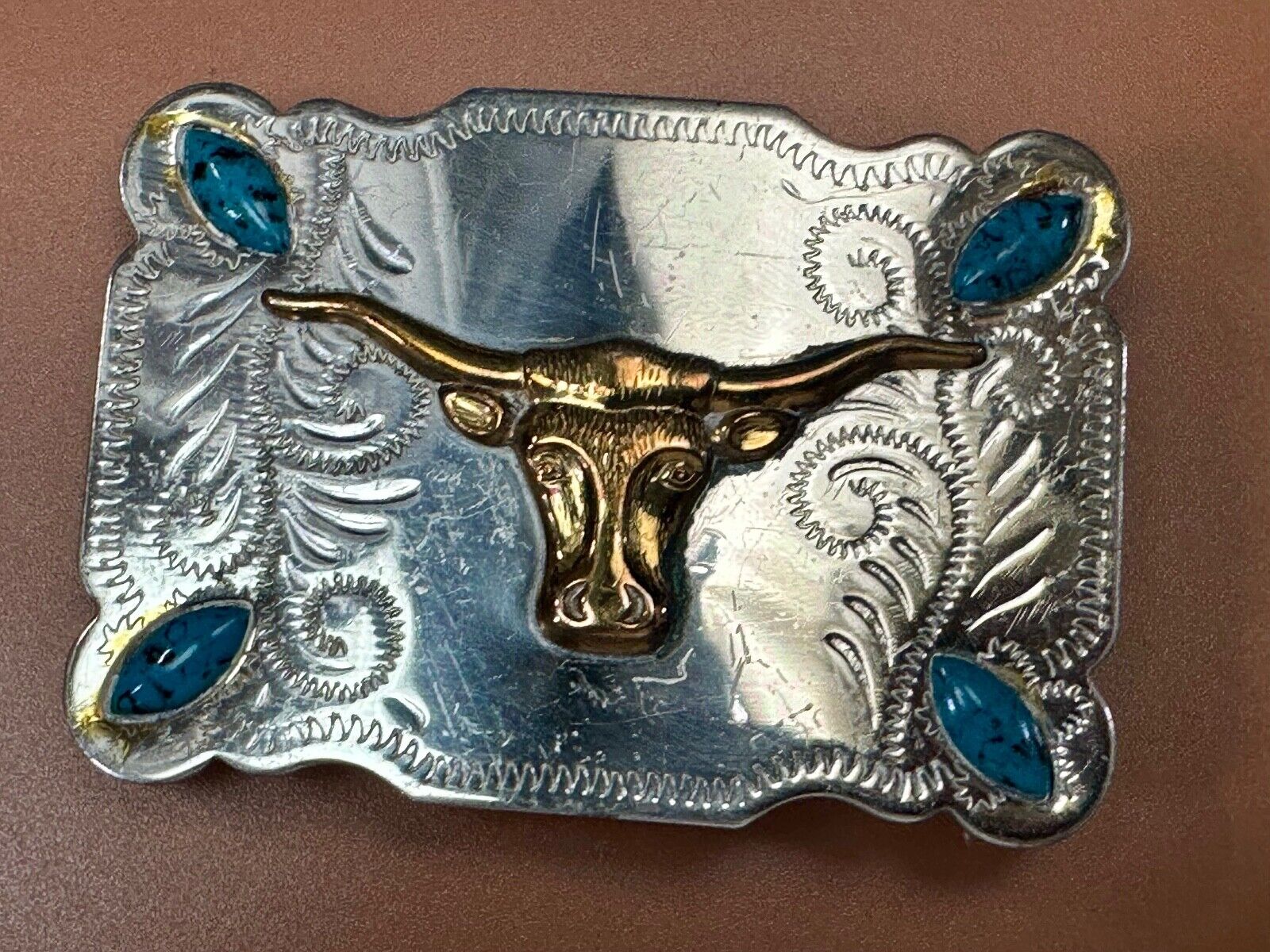 The Longhorn cow steer western nickel silver belt buckle with turquoise accents