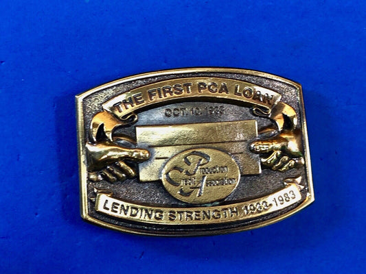 The first PCA loan belt buckle - Lending and strength  production credit assn.