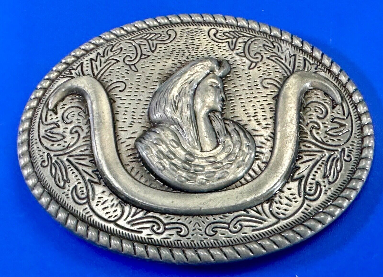 unknown to me!   Man with long hair - longhorn wester belt buckle
