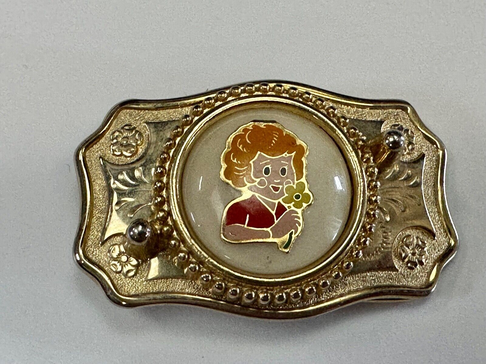 Adorable red headed girl with flower as centerpiece on western belt buckle