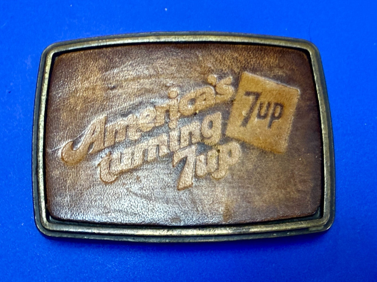 America's Turning 7up Embossed Leather on Metal Advertising Promo Belt Buckle