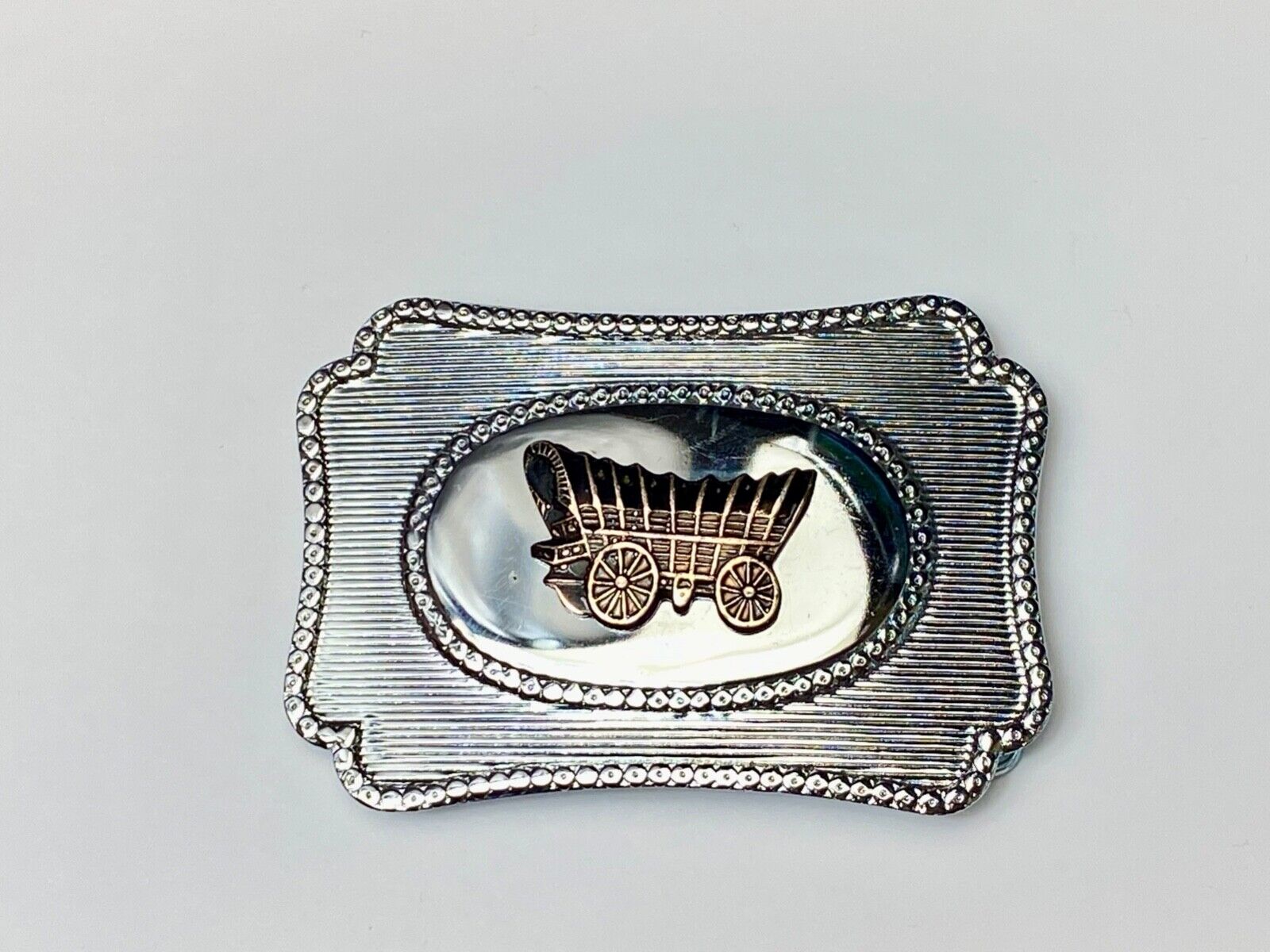 Vintage Covered wagon two tone reflective pre loved, western framed belt buckle