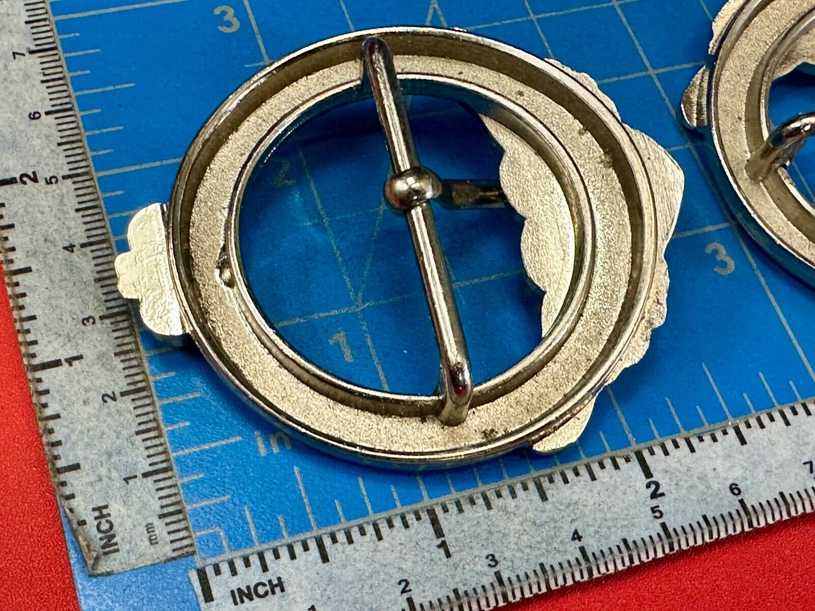 Two Kathy Van Zeeland signed silver tone round heart accented belt buckles