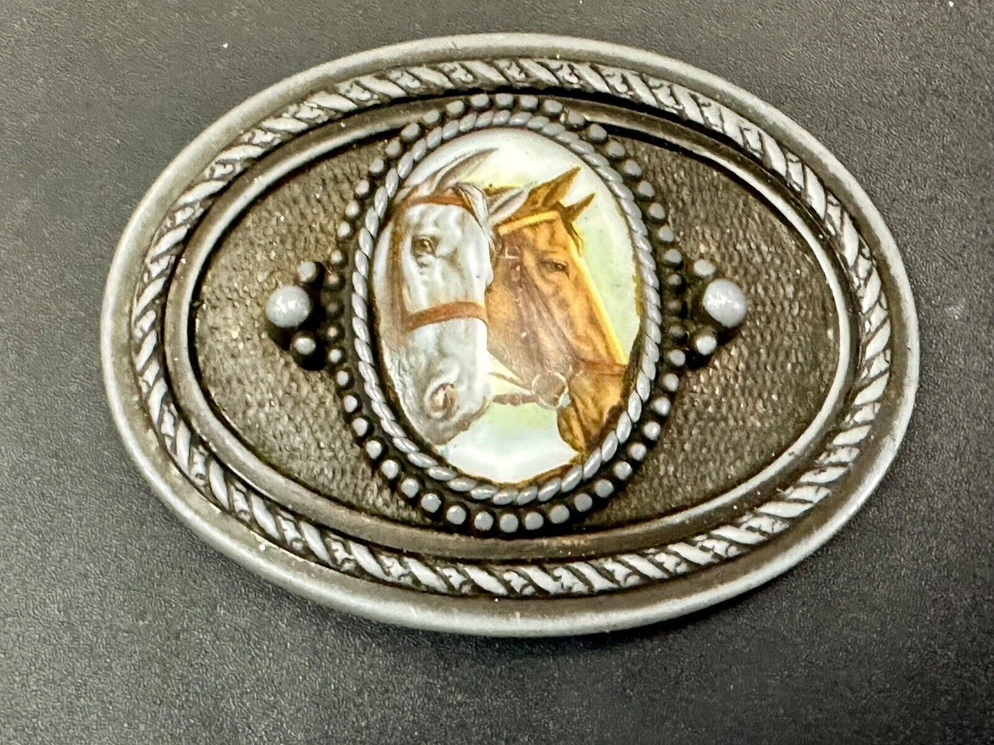 2 horses picture as centerpiece in western oval belt buckle with rope border