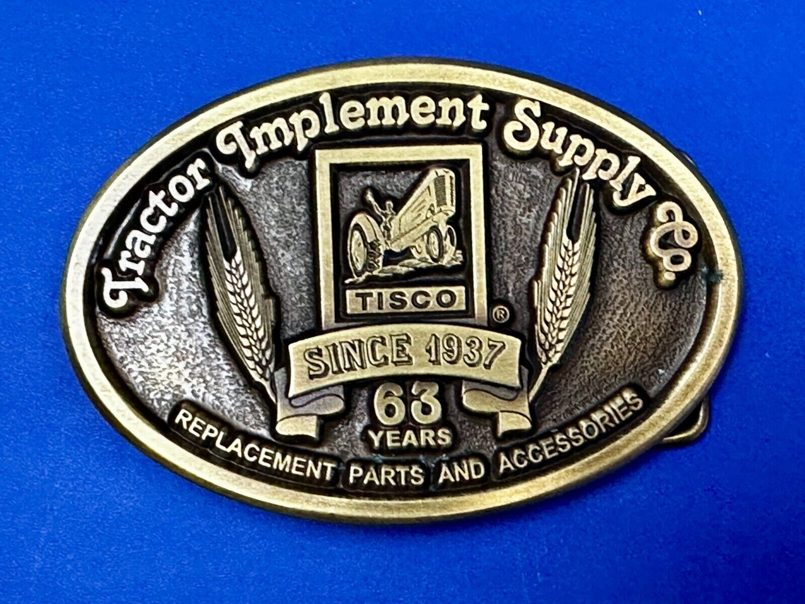 63 years TISCO Tractor Implement Supply company Vintage Belt Buckle by Speccast