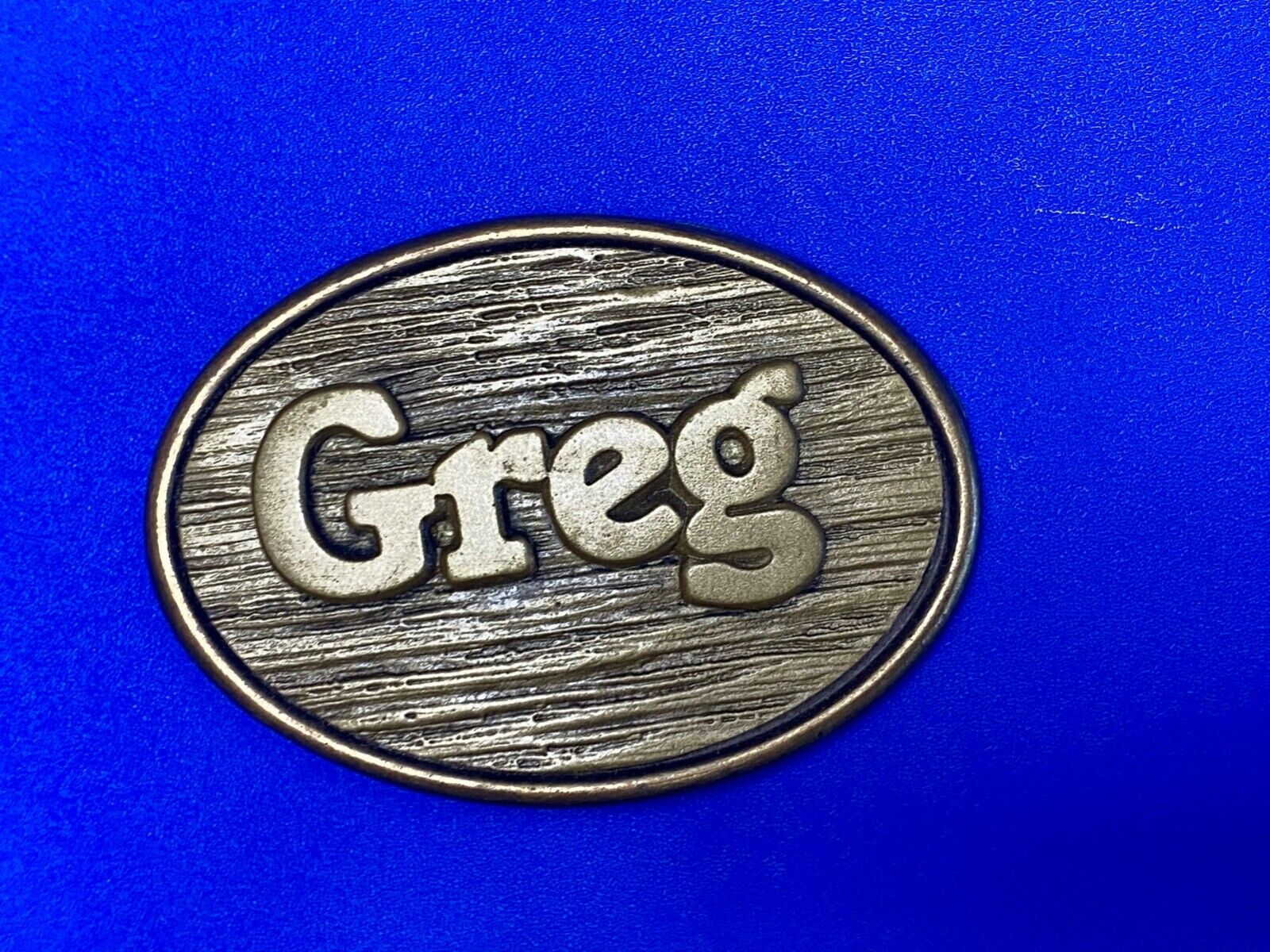 Vintage GREG name metal wood grain western Belt Buckle By Oden - Made In USA