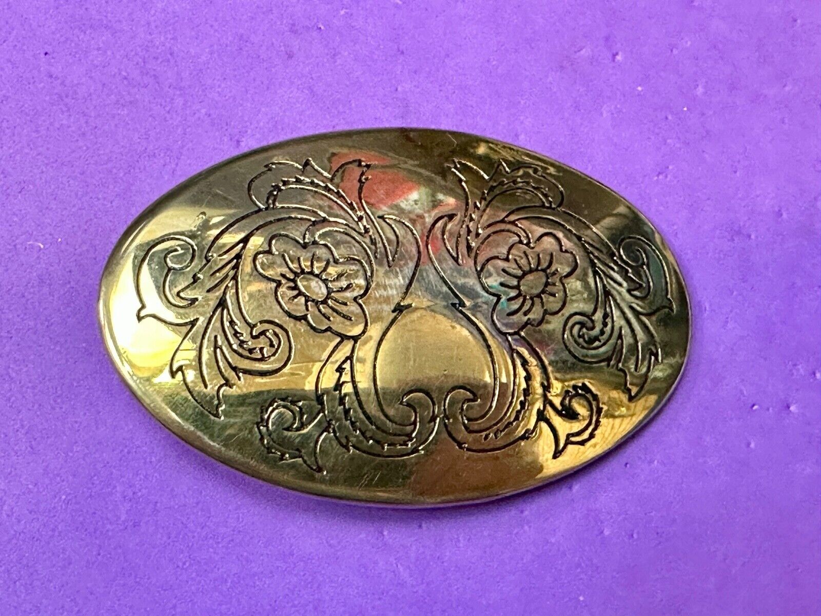 Antique? Engraved flower swirl pattern on gold color oval belt buckle
