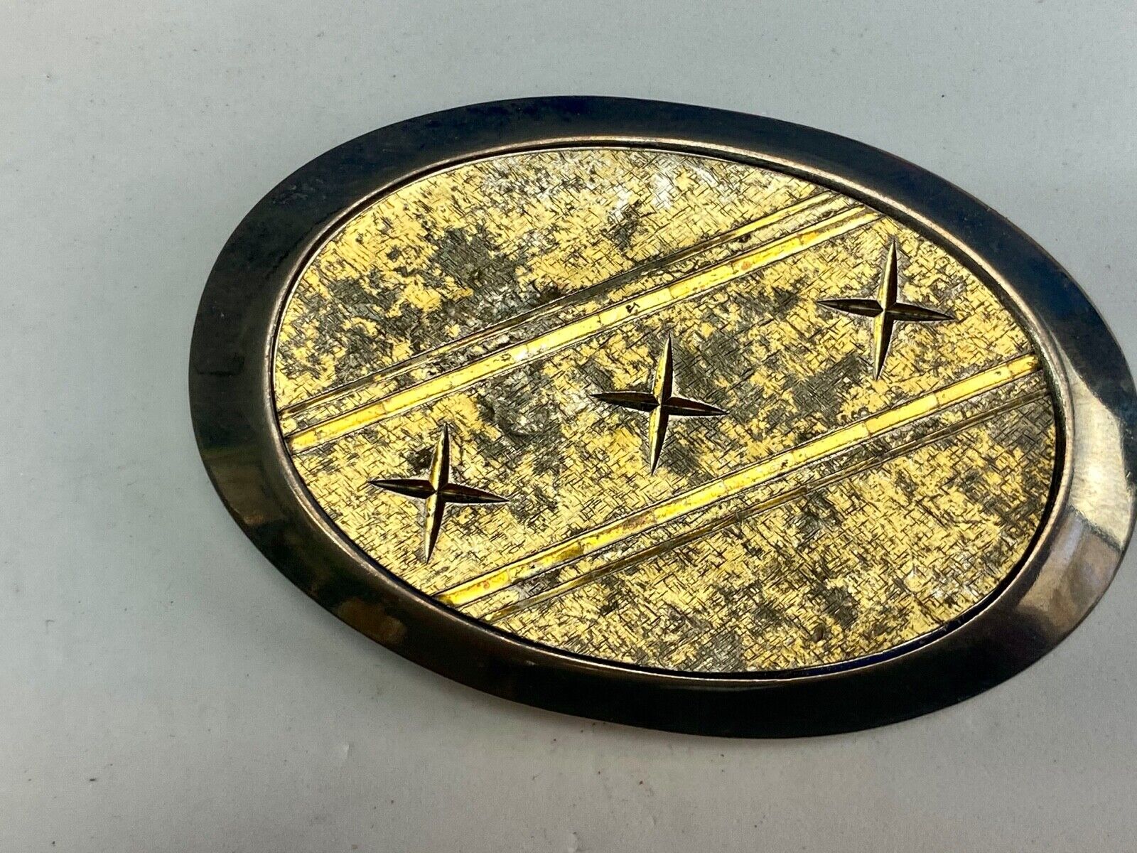 Unique XXX gold tone belt buckle tic tac toe pattern