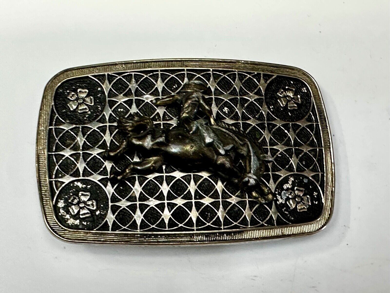 Vintage Cowboy on Saddle Bronc Western belt buckle with mesh pattern background