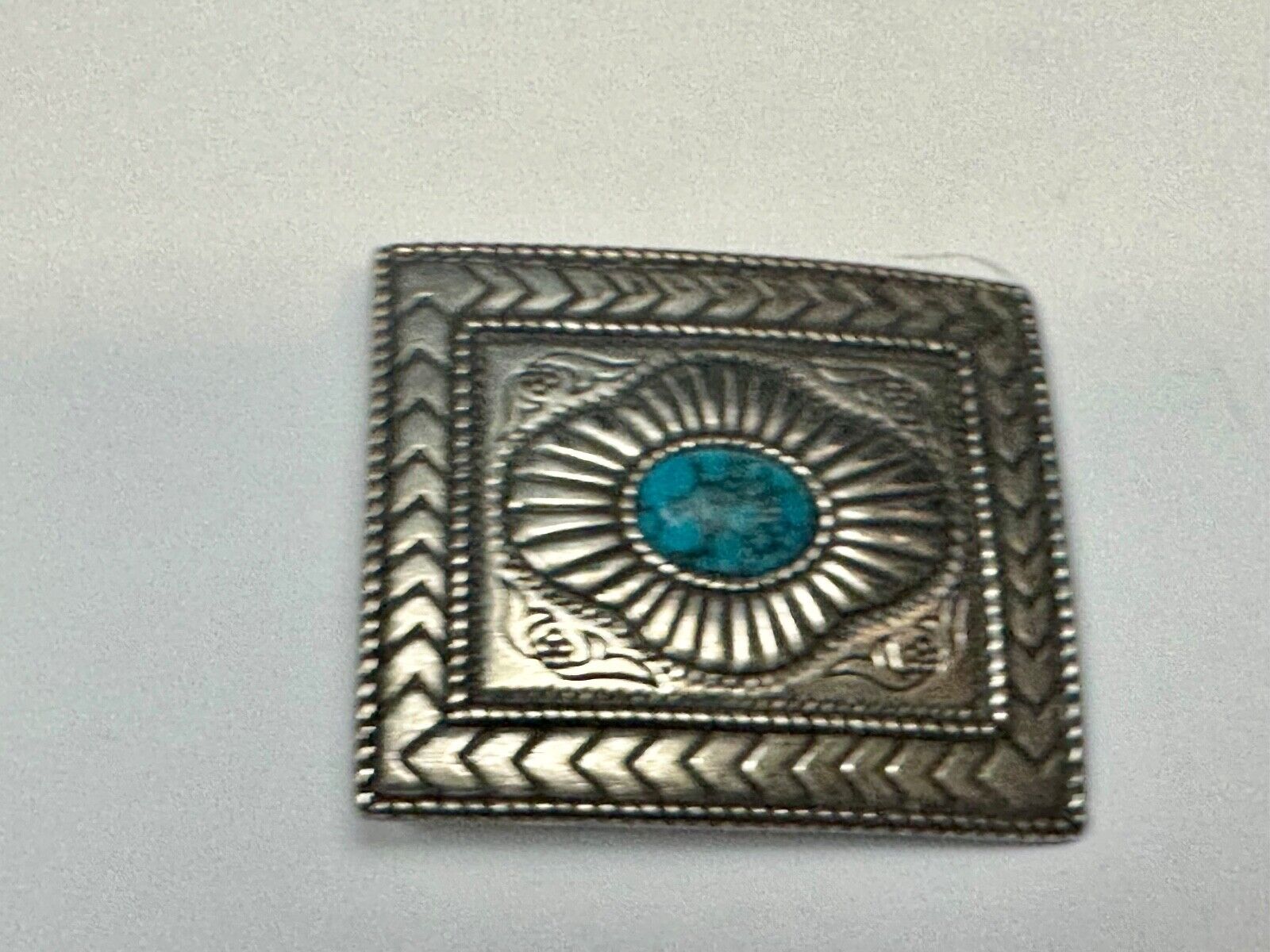 Turquoise Cab centerpiece on southwestern pattern silver tone belt buckle