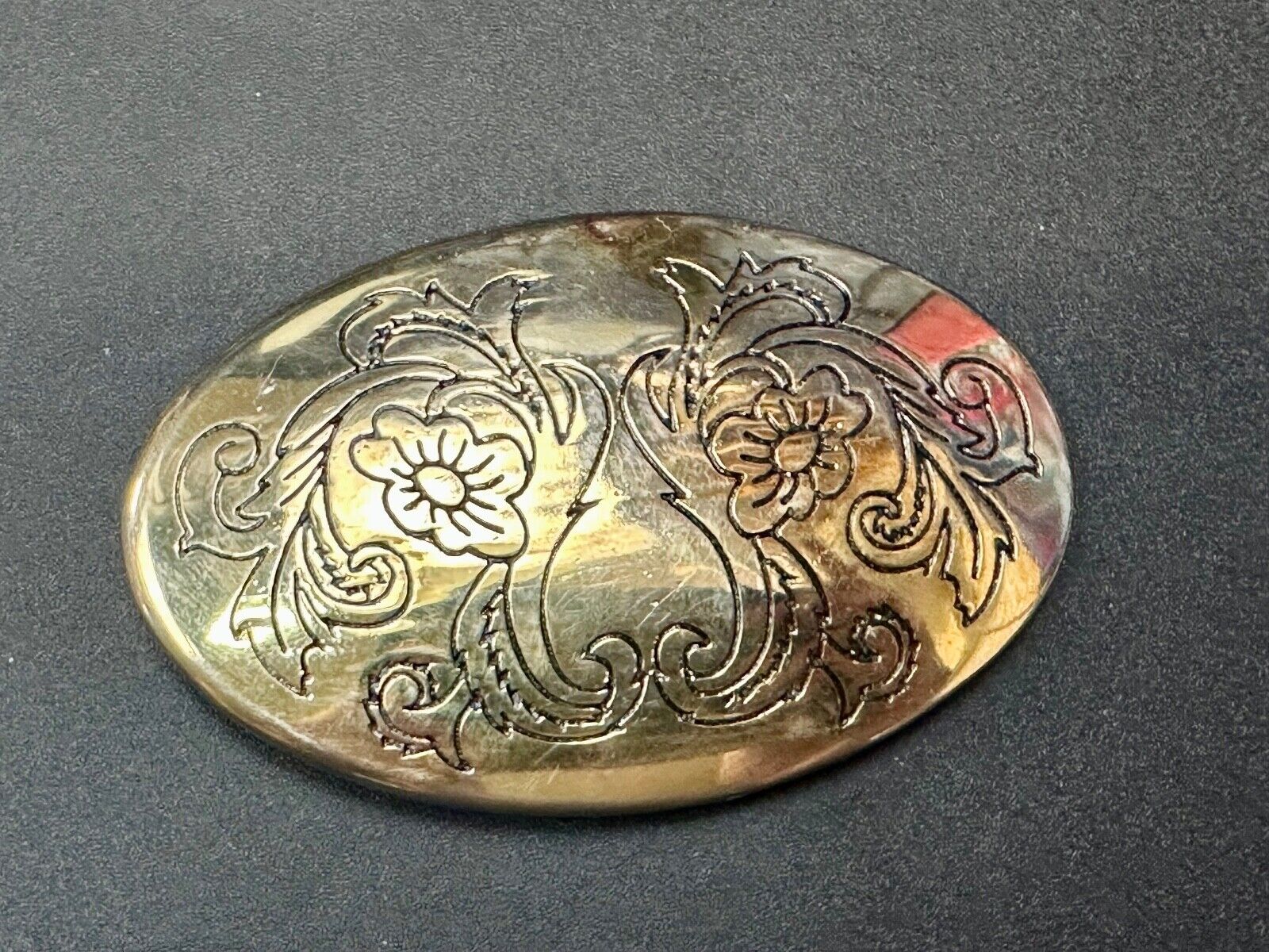 Antique? Engraved flower swirl pattern on gold color oval belt buckle