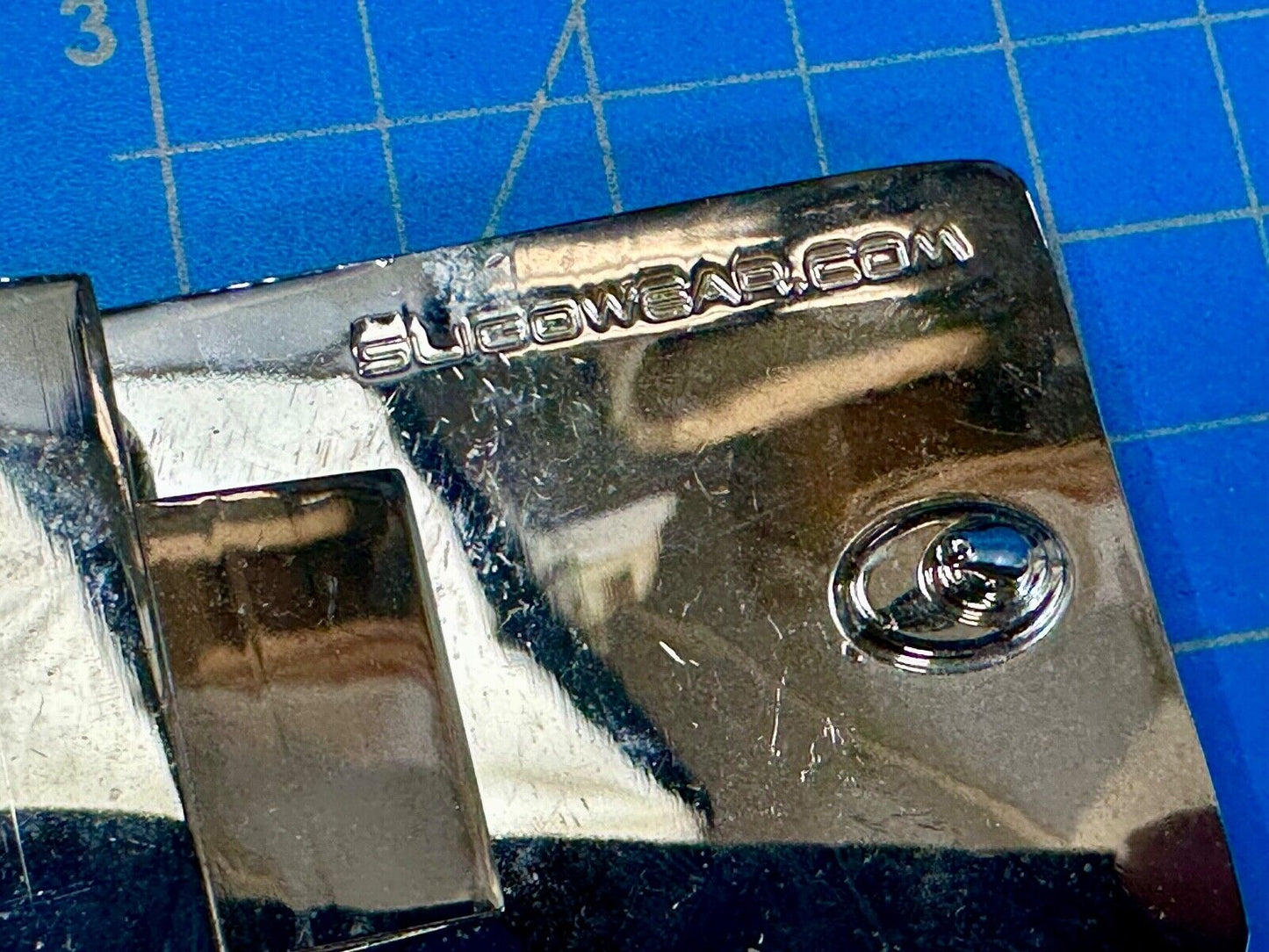 unknown to me!   Sligo Sugowear blue colored emblem or logo belt buckle