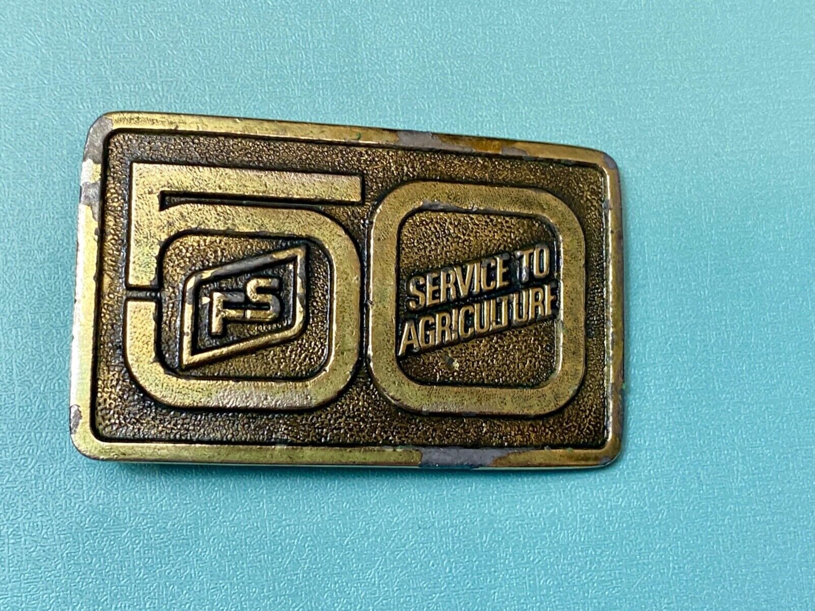 50 years, Farm Service to Agriculture belt buckle by Wyoming Studio Art works