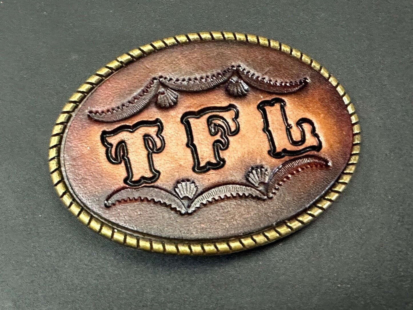 TFL.  vintage western initials letters on leather belt buckle