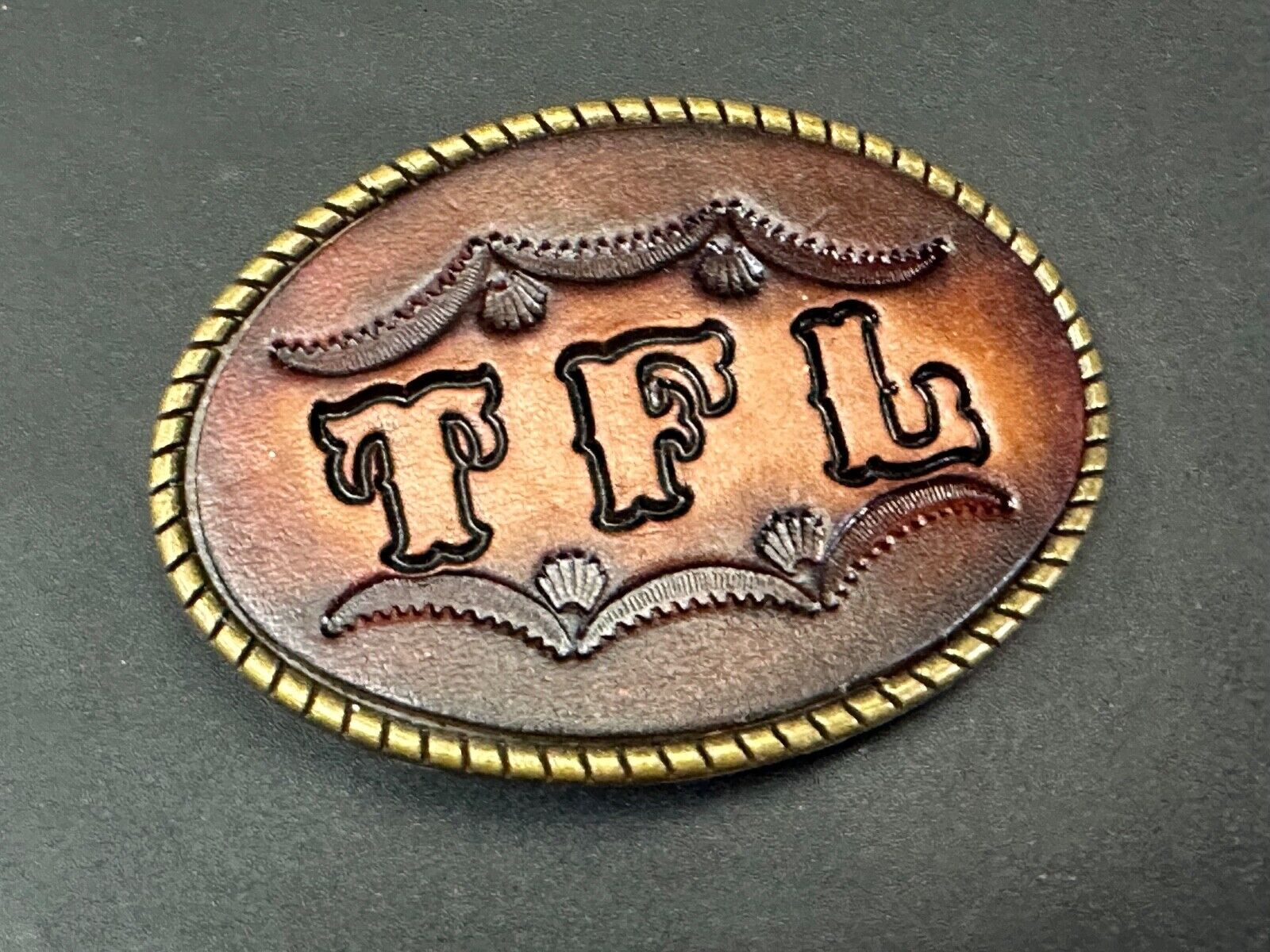 TFL.  vintage western initials letters on leather belt buckle