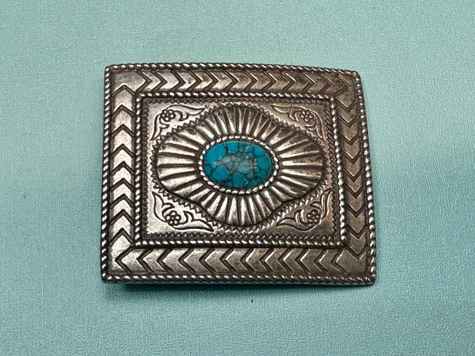 Turquoise Cab centerpiece on southwestern pattern silver tone belt buckle