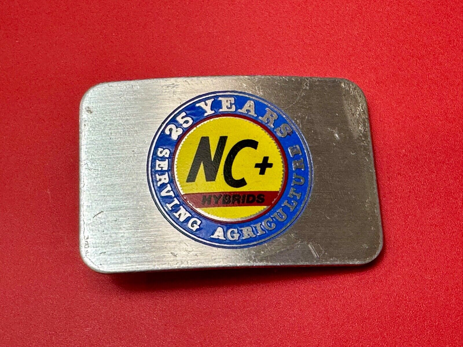 25 years serving agriculture - NC+ Hybrids Farmers Agriculture belt buckle