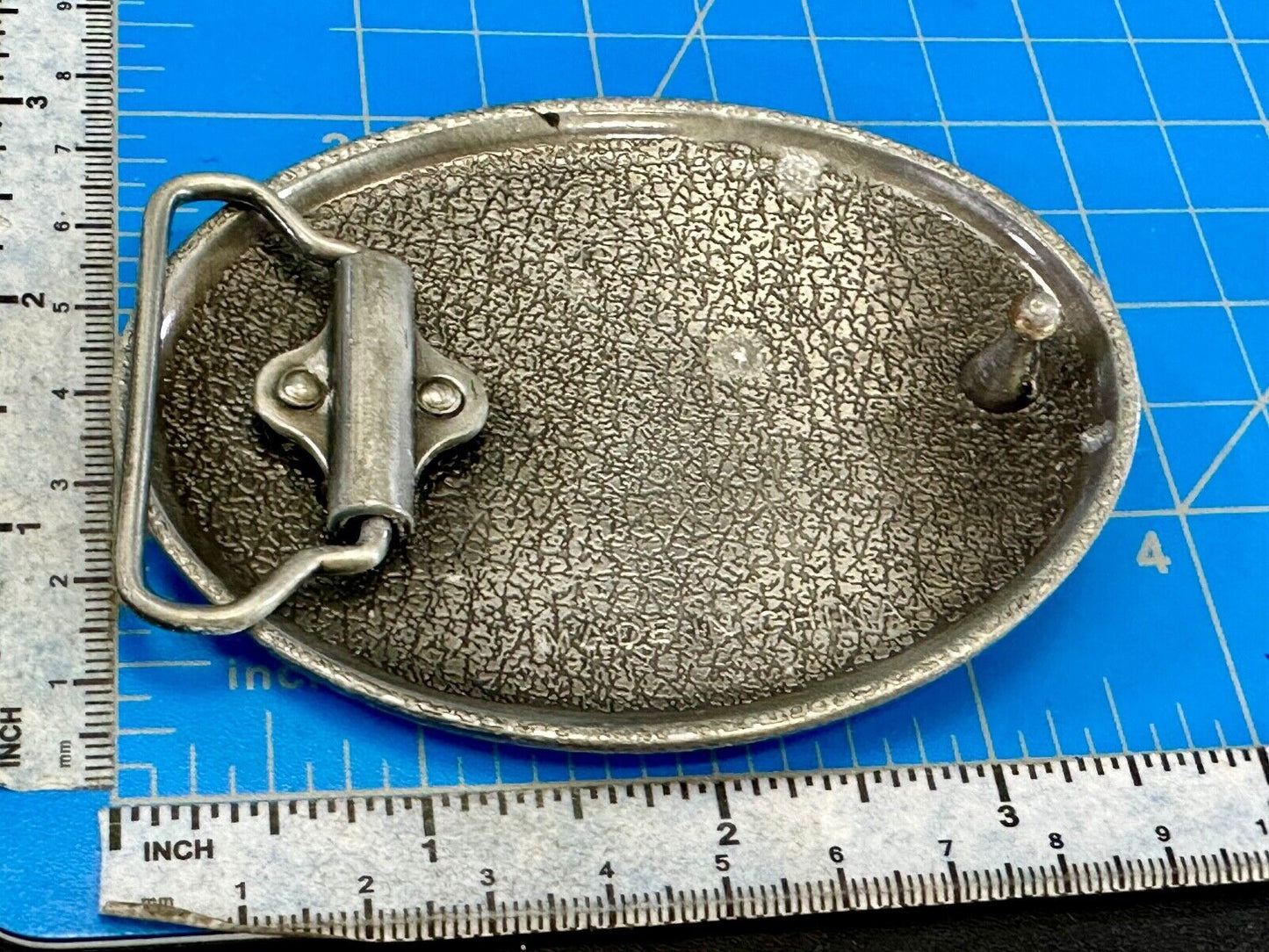 unknown to me!   Man with long hair - longhorn wester belt buckle