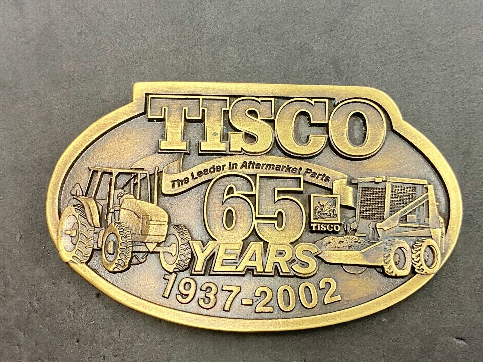 65 years - Tisco Tractor Implement Supply Spec Cast Farming Belt Buckle 