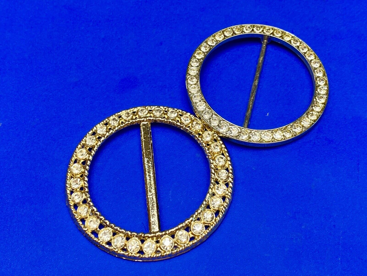 Two piece lot of antique Rhinestone covered round scarf slides