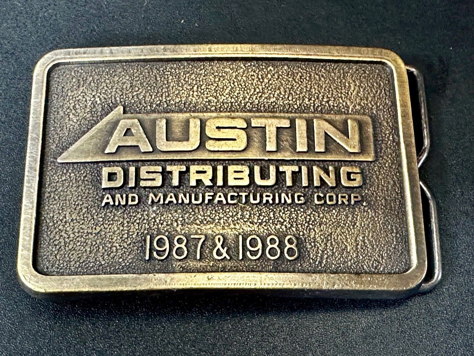 Austin Texas Distributing and Manufacturing 1987 Advertisement Promo Belt Buckle