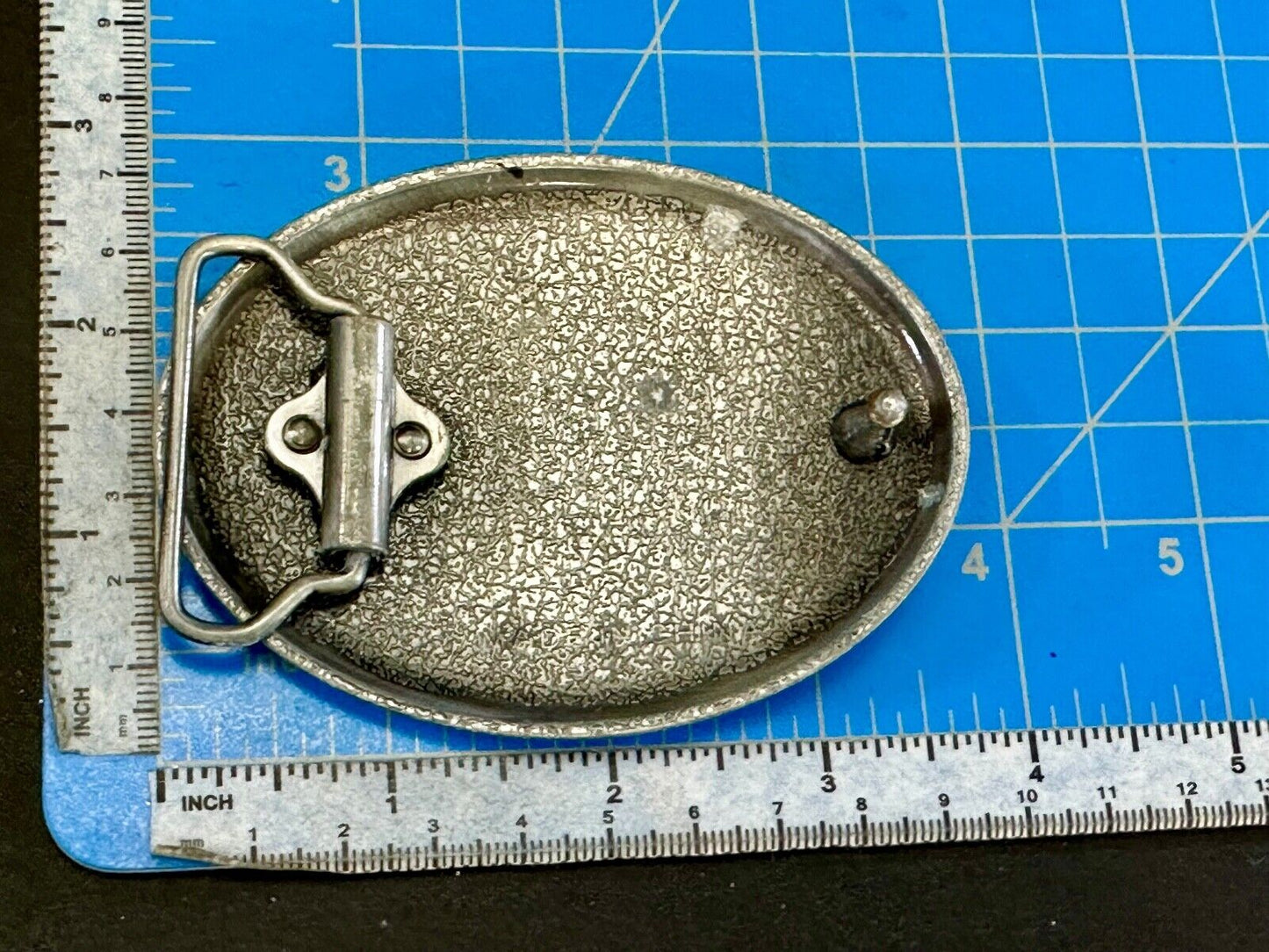 unknown to me!   Man with long hair - longhorn wester belt buckle