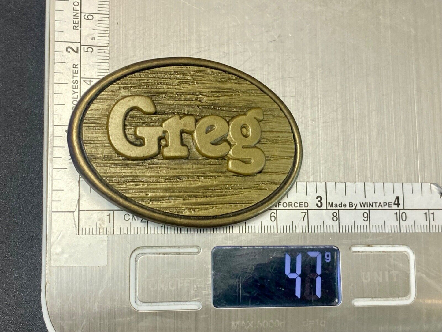 Vintage GREG name metal wood grain western Belt Buckle By Oden - Made In USA