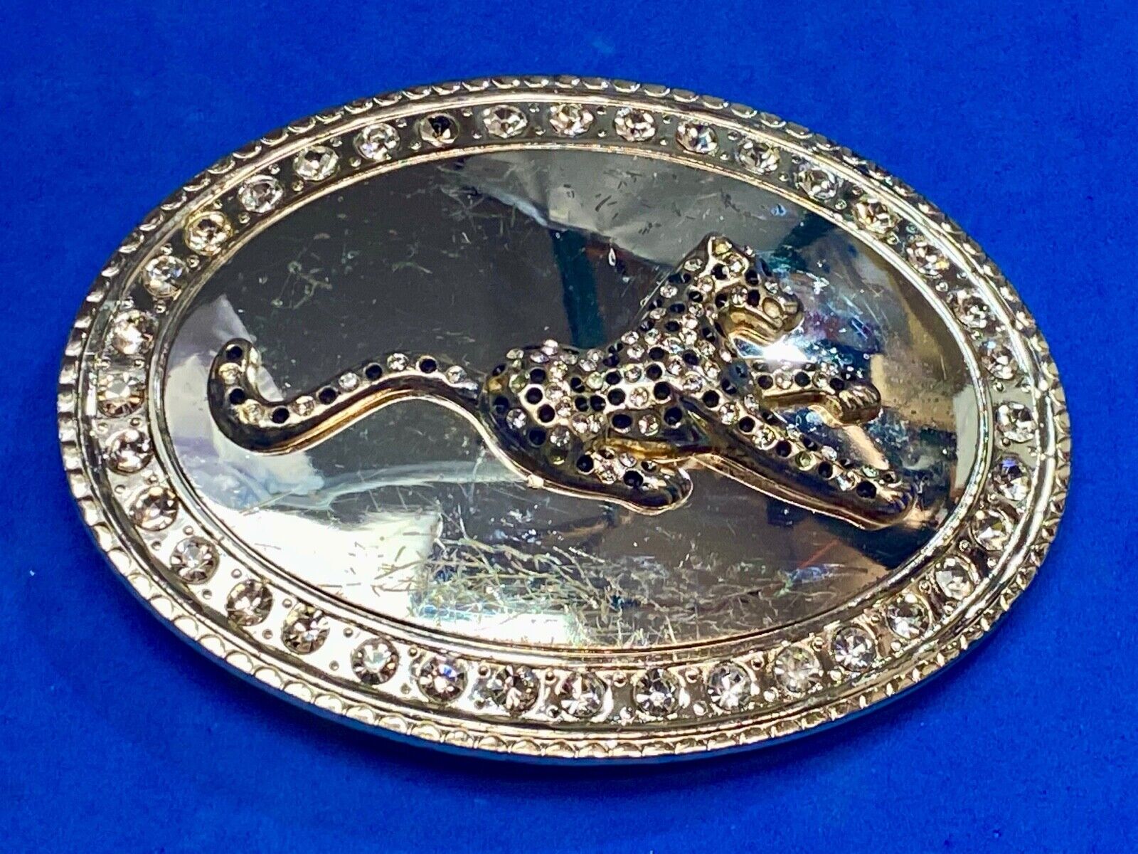 A big Tiger Cat running featured on western oval belt buckle 
