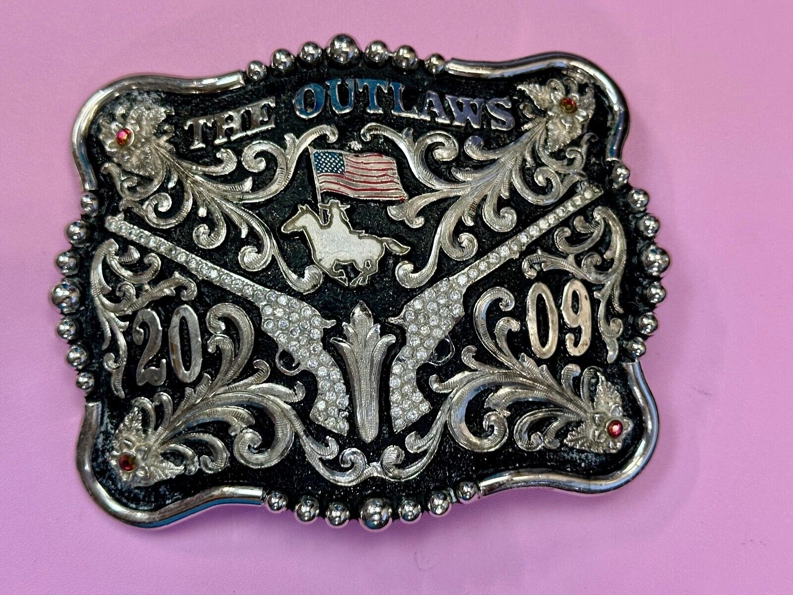 The Outlaws Rodeo Cowboy Trophy 2009 Flag Belt Buckle - Crossroads bucklesTexas
