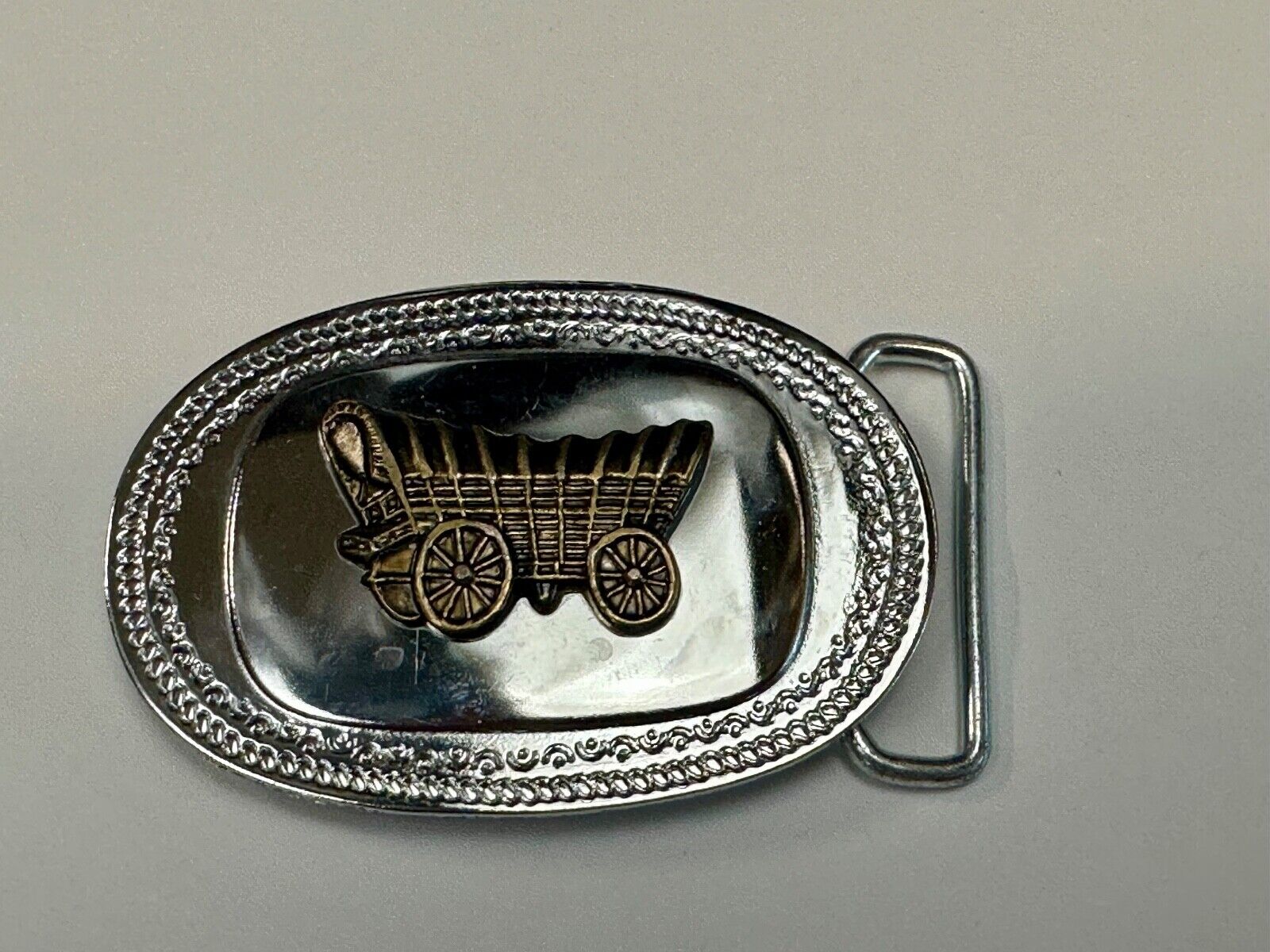 Vintage Covered Wagon on reflective oval two tone western belt buckle