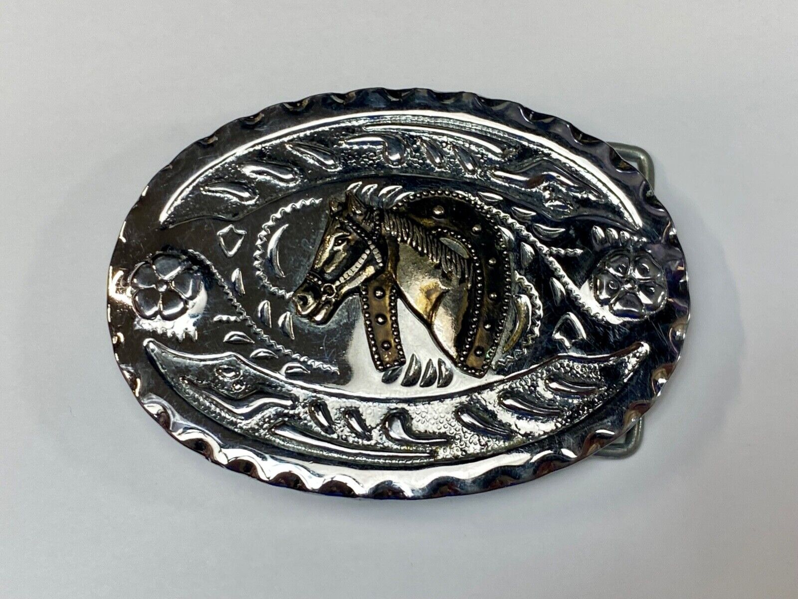 Vintage horse head through lucky horseshoe on mixed metal western belt buckle