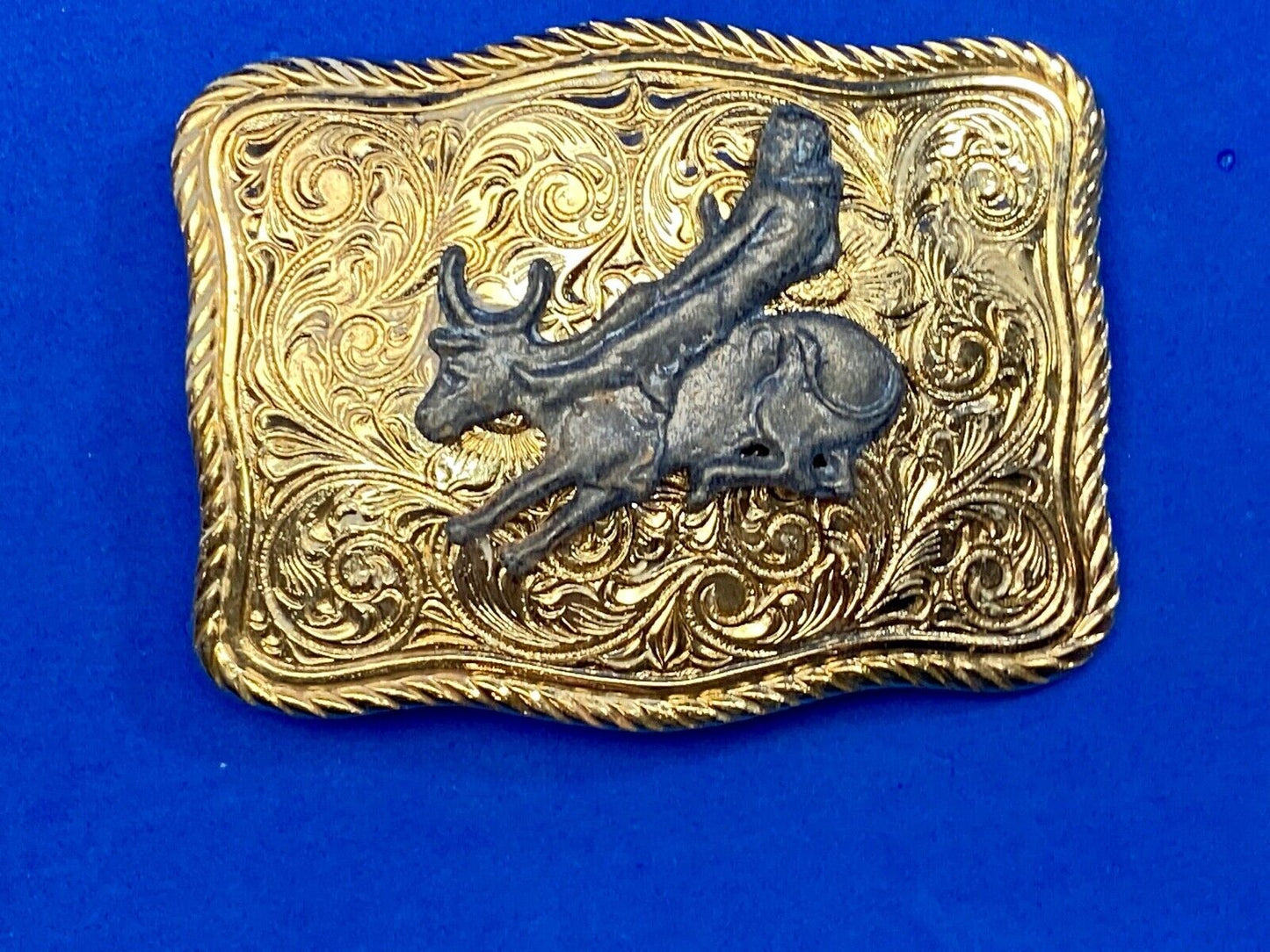 bull riding rodeo cowboy on beautiful gold color flower swirl belt buckle 