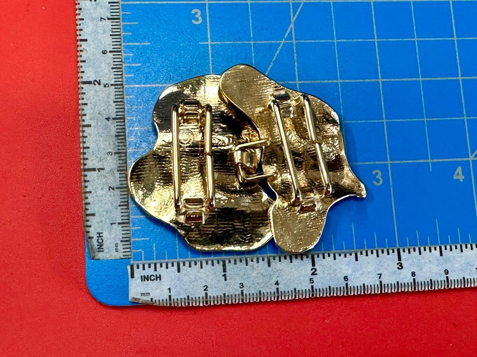 Two-piece interlocking gold tone leaf swirl theme belt slide buckle signed _____