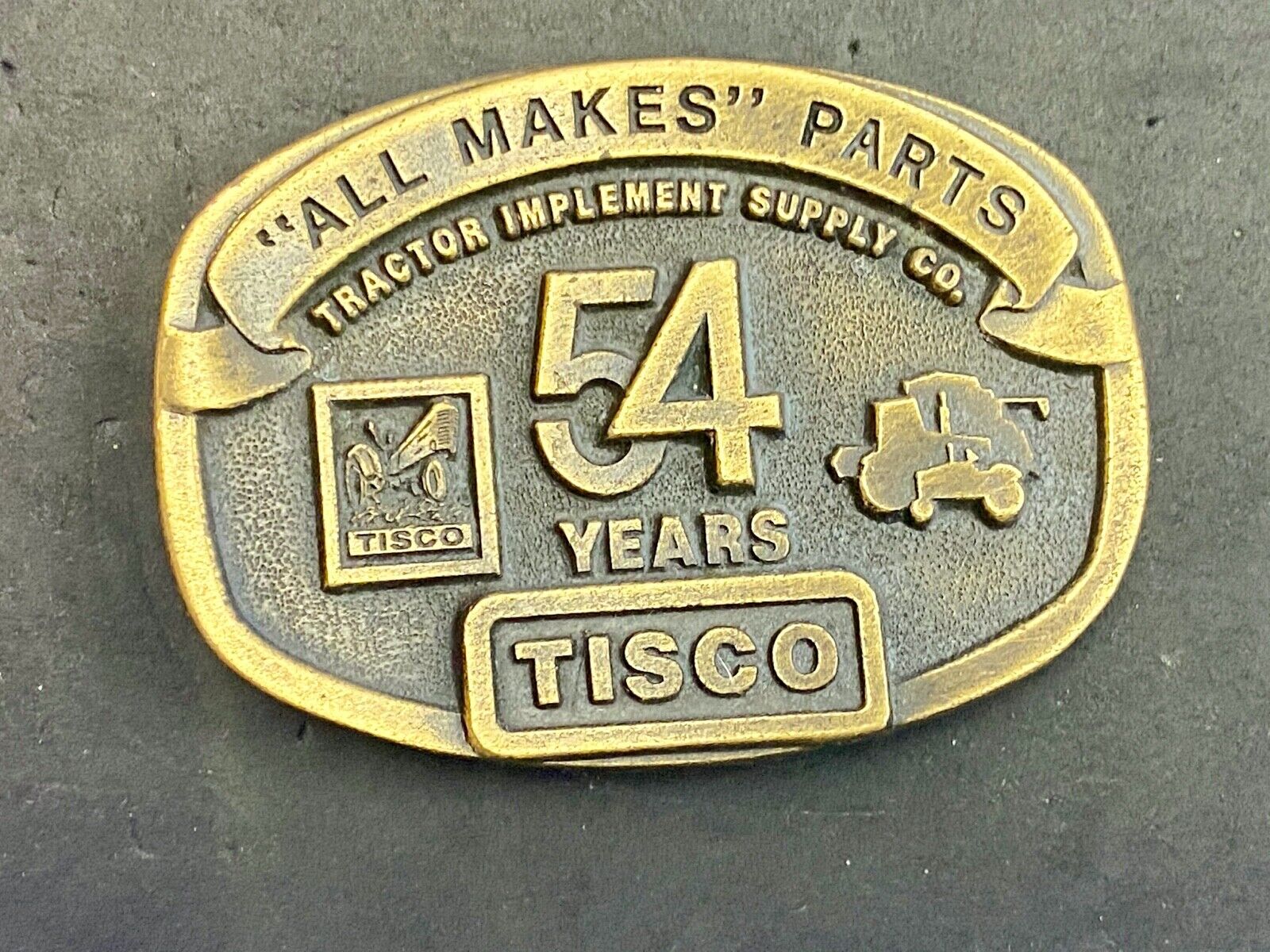 54 years Tisco Tractor Implement Supply Spec Cast Brass Belt Buckle series 2