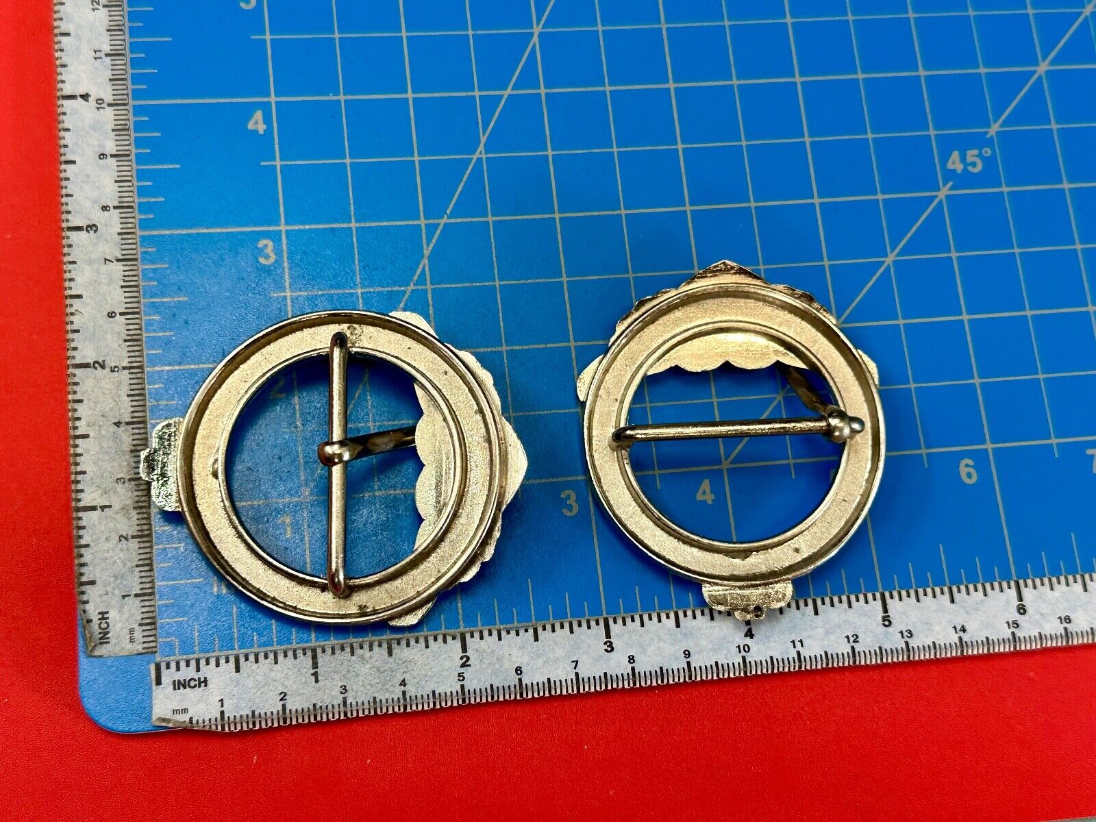 Two Kathy Van Zeeland signed silver tone round heart accented belt buckles