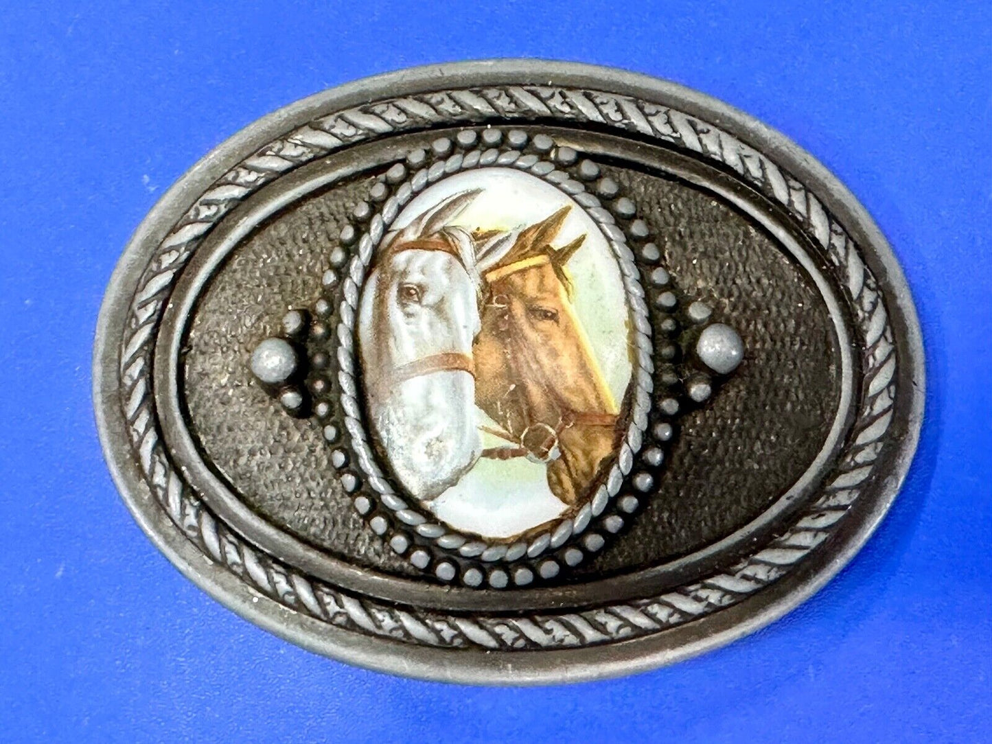 2 horses picture as centerpiece in western oval belt buckle with rope border