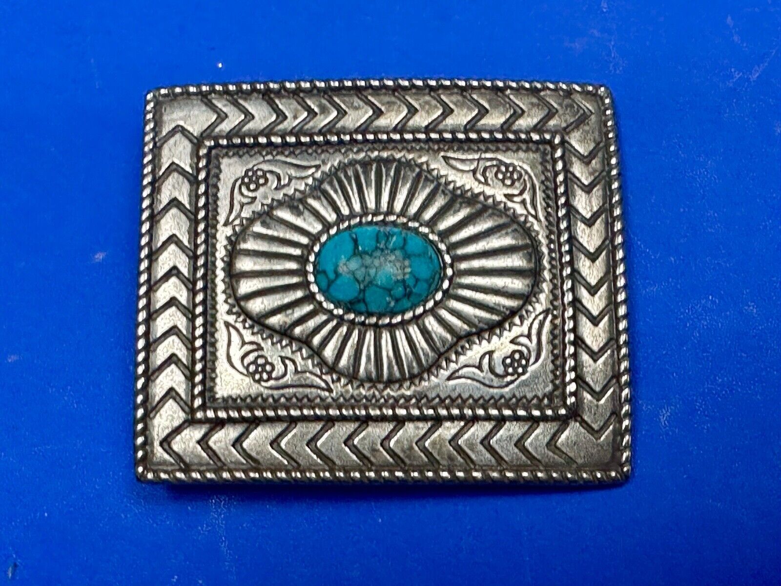 Turquoise Cab centerpiece on southwestern pattern silver tone belt buckle