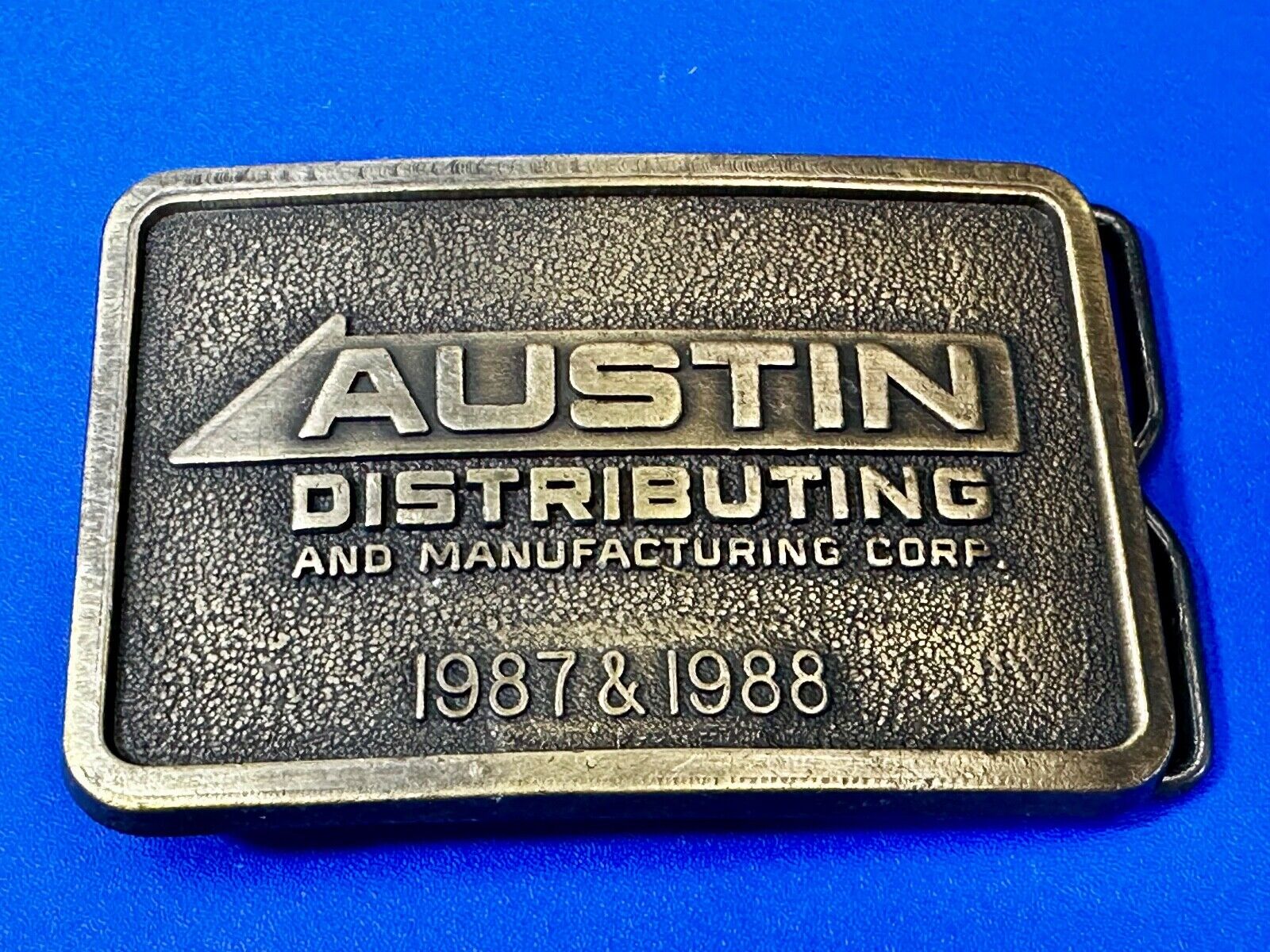 Austin Texas Distributing and Manufacturing 1987 Advertisement Promo Belt Buckle