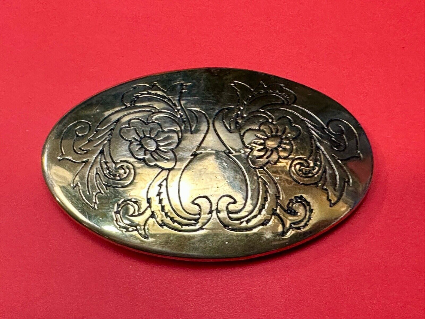Antique? Engraved flower swirl pattern on gold color oval belt buckle