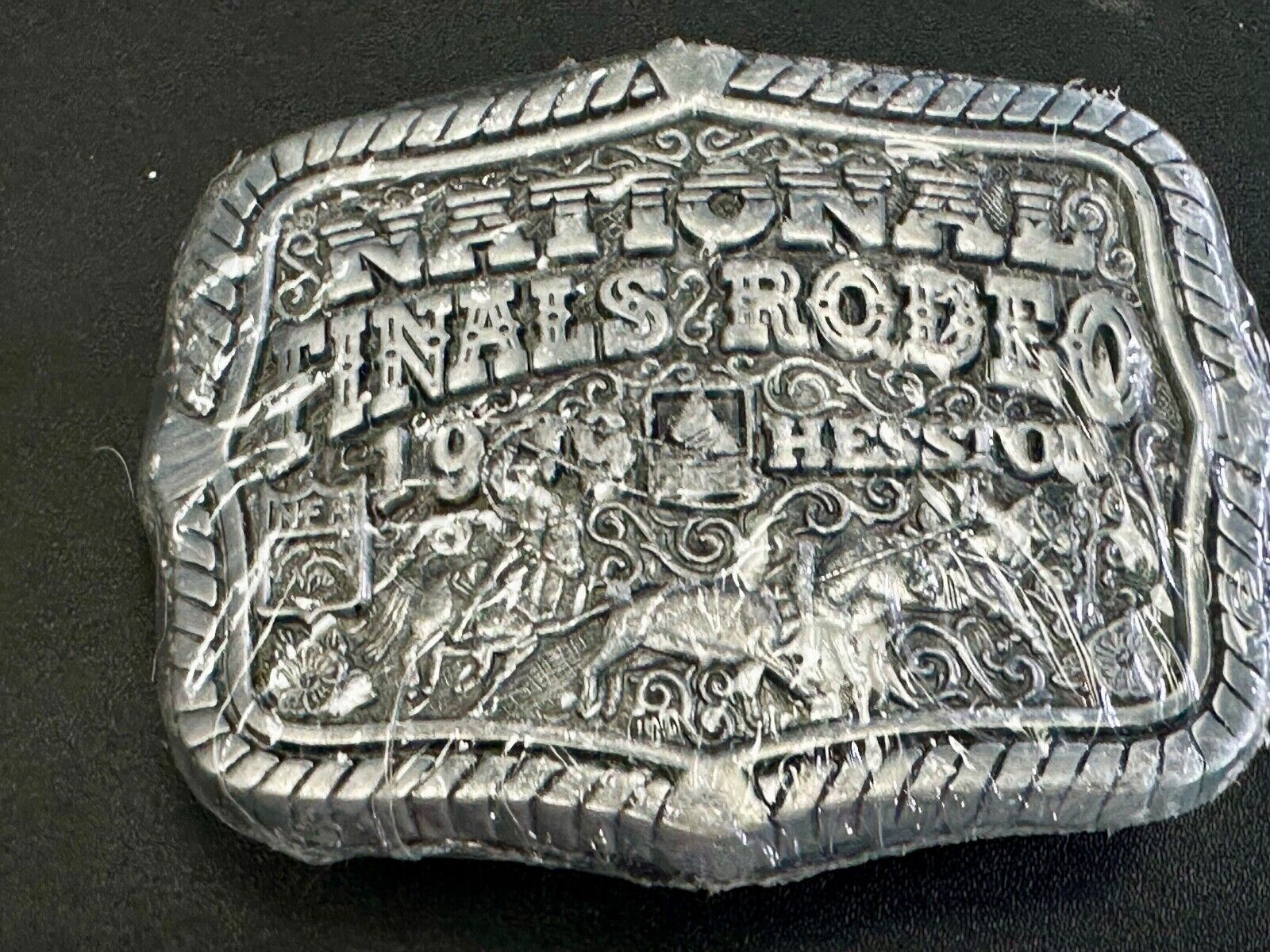 1999 Youth Sized Hesston National Finals Rodeo 2000 series belt buckle in wrap
