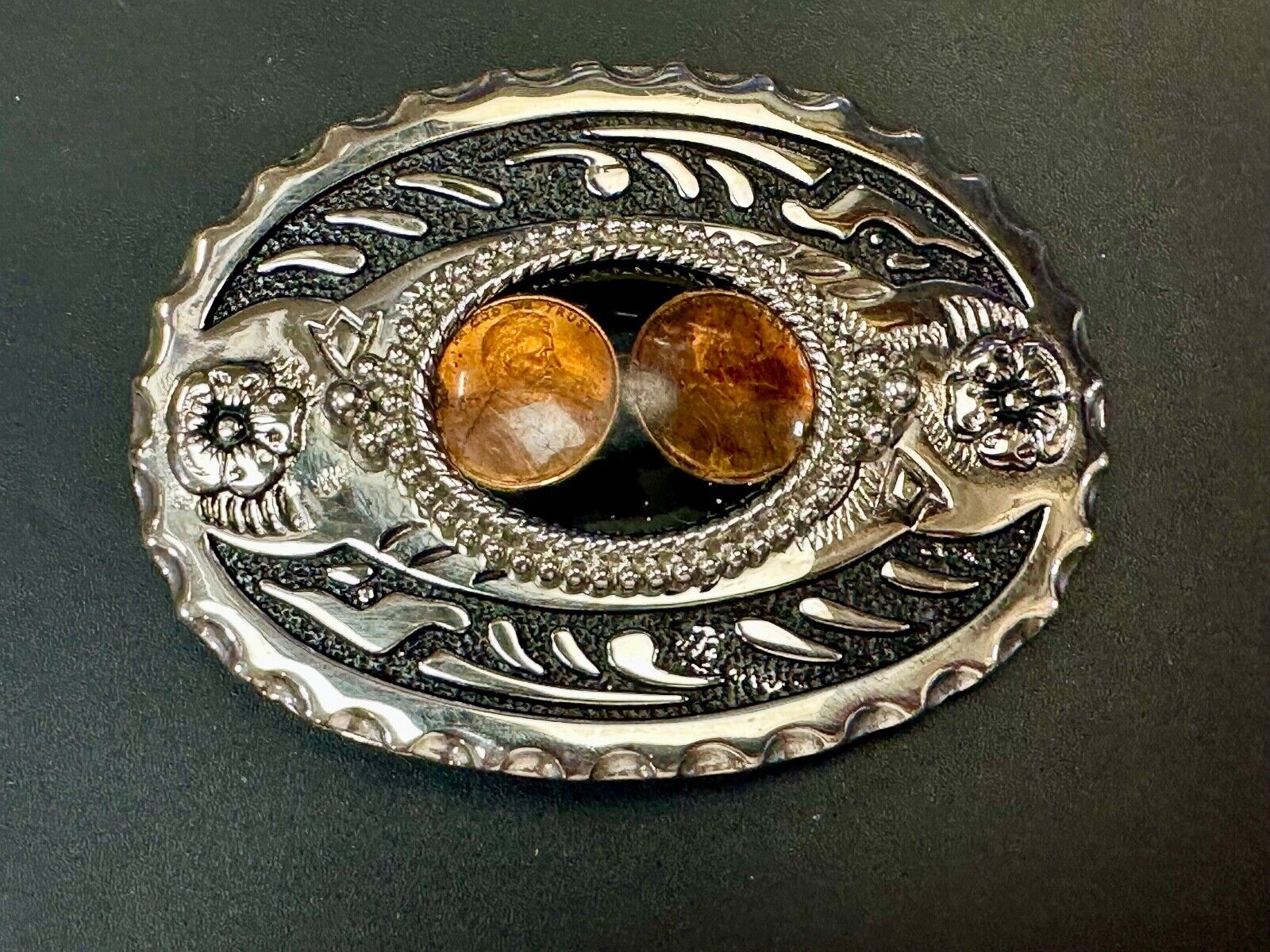 Two lucky pennies coins encased in cab style centerpiece of western belt buckle