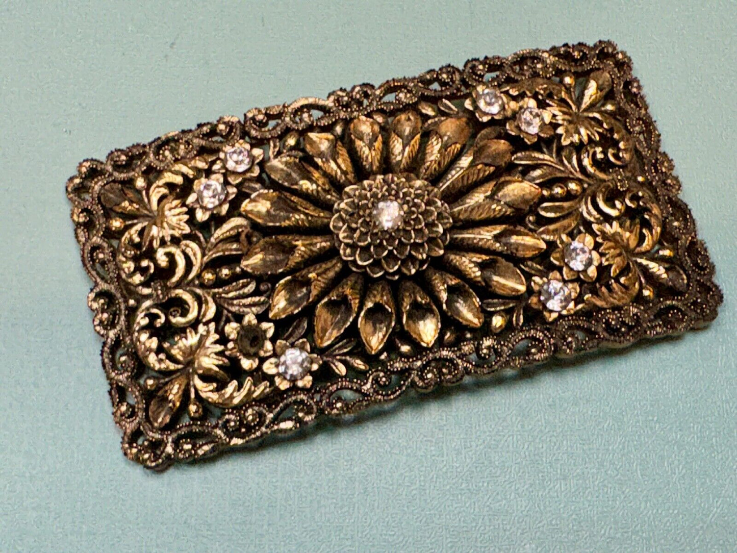 Antique gold tone? Flower theme Rhinestone covered scarf slide belt loupe buckle