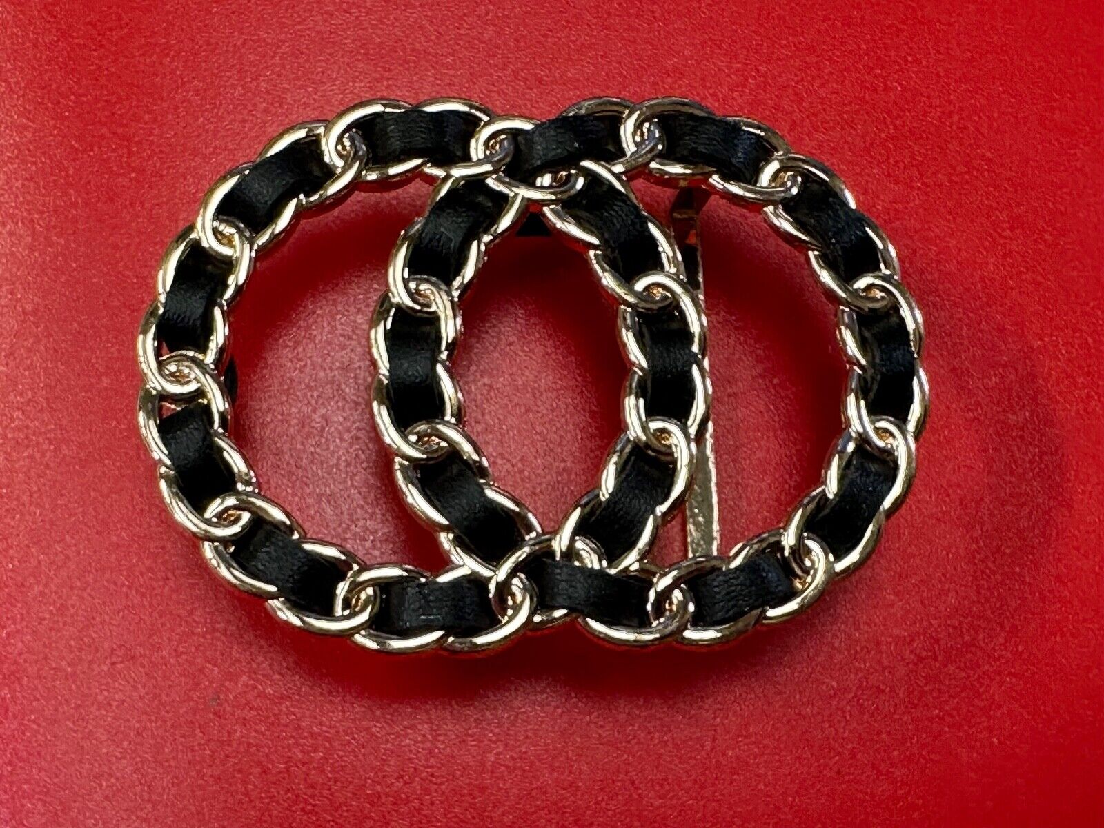 Two gold tone Overlapping Circle's with black ribbon through-out belt buckle